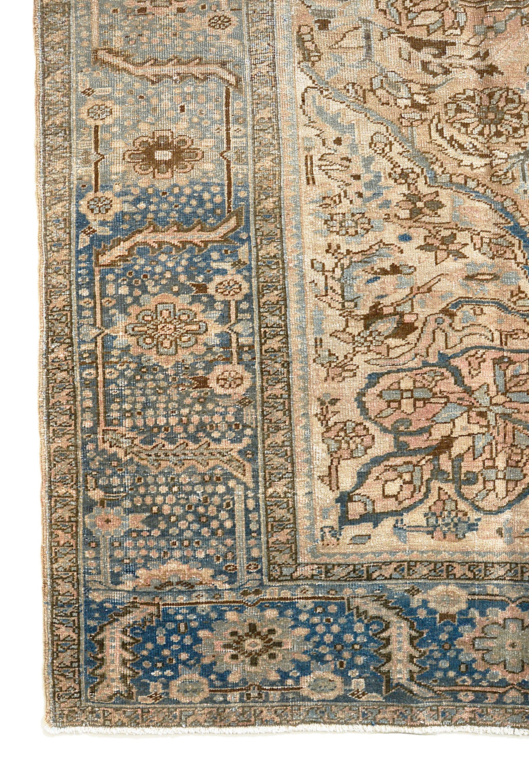 Vintage Persian Heriz carpet corner detail showing hand-knotted wool and traditional floral border
