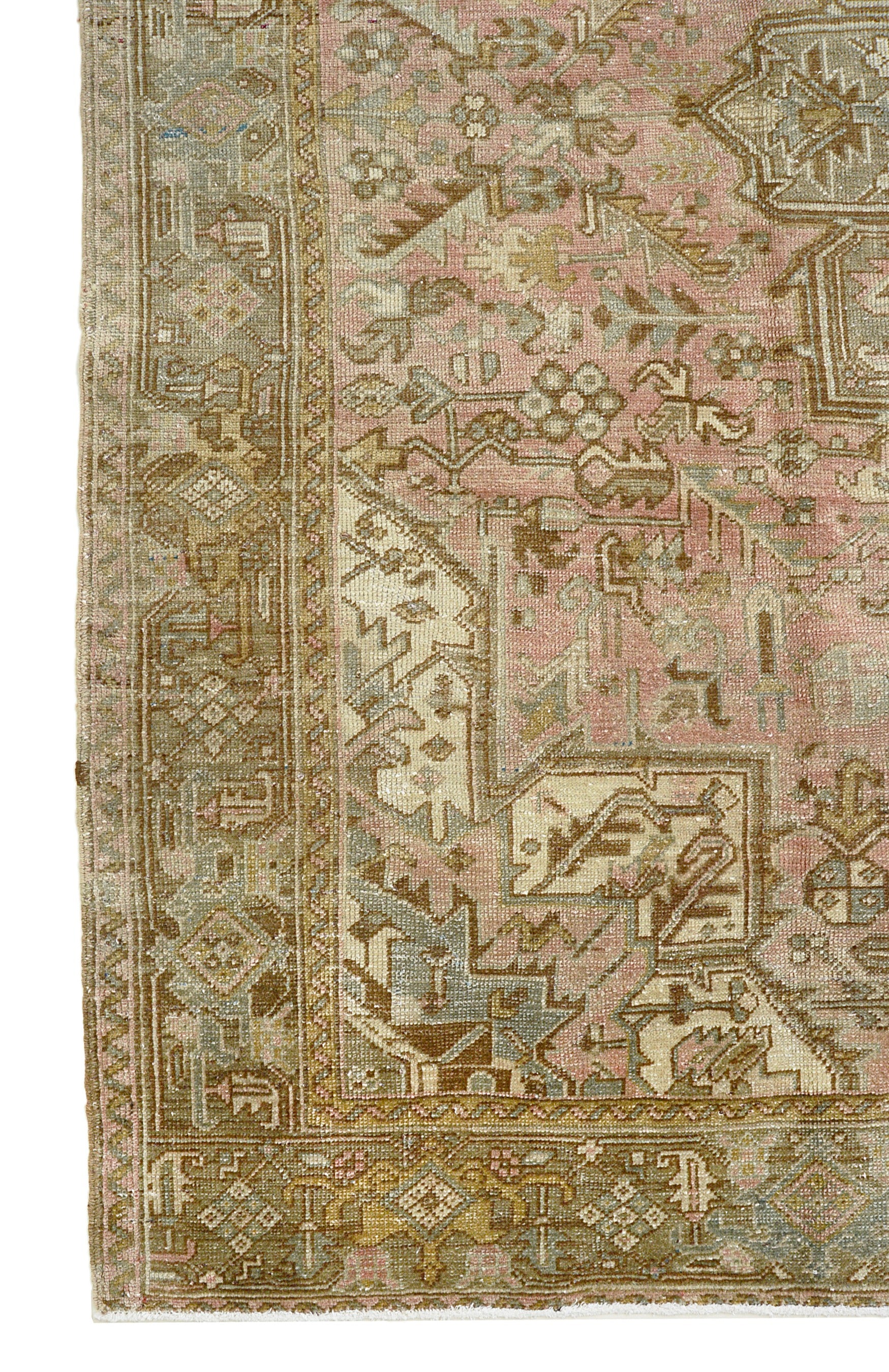 Vintage Persian Heriz rug corner detail showing hand-knotted wool pile, geometric border motifs and aged patina, circa 1940

