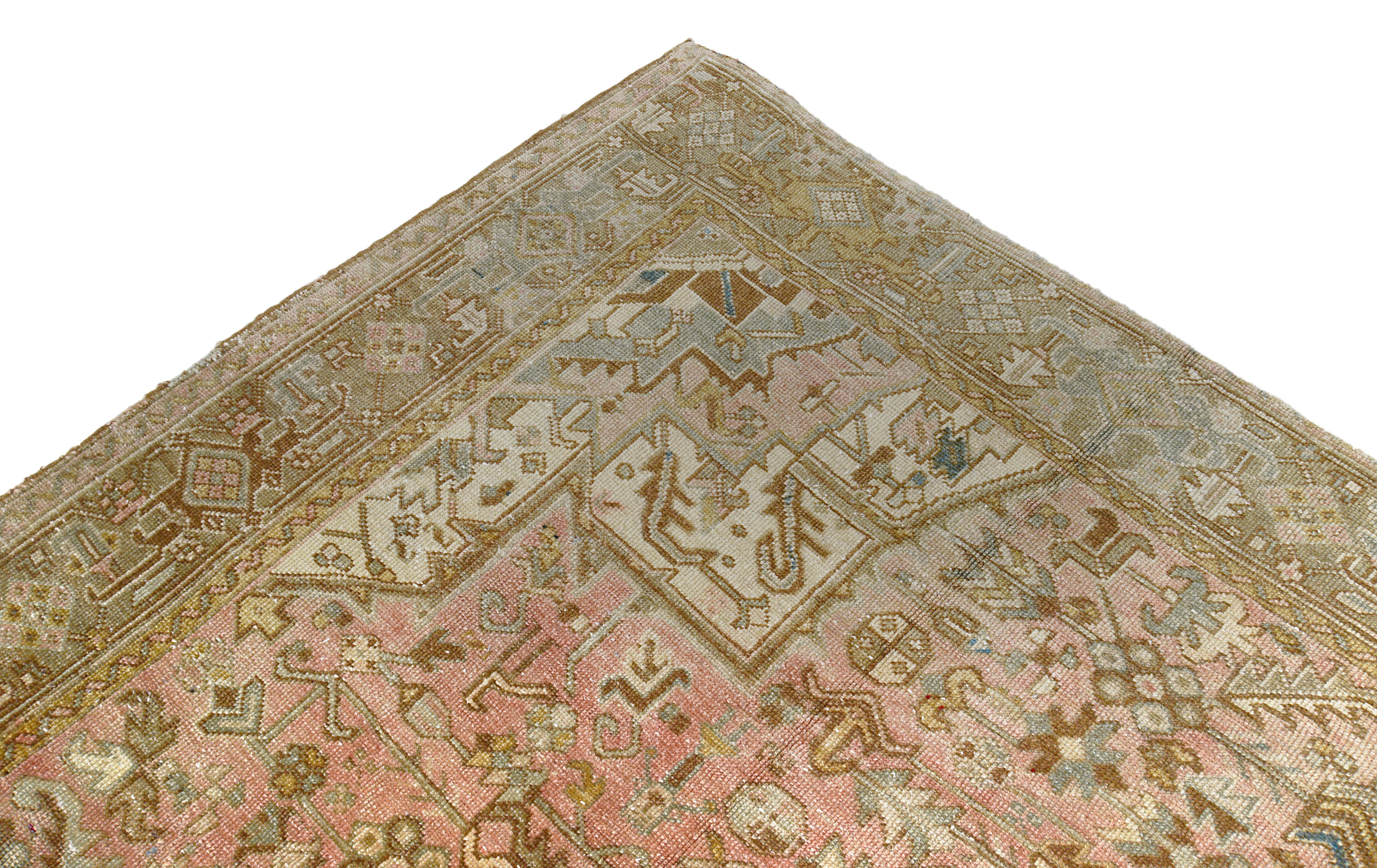 Detail of vintage Persian Heriz carpet showing wool texture, geometric motifs and natural colour variation from age and use

