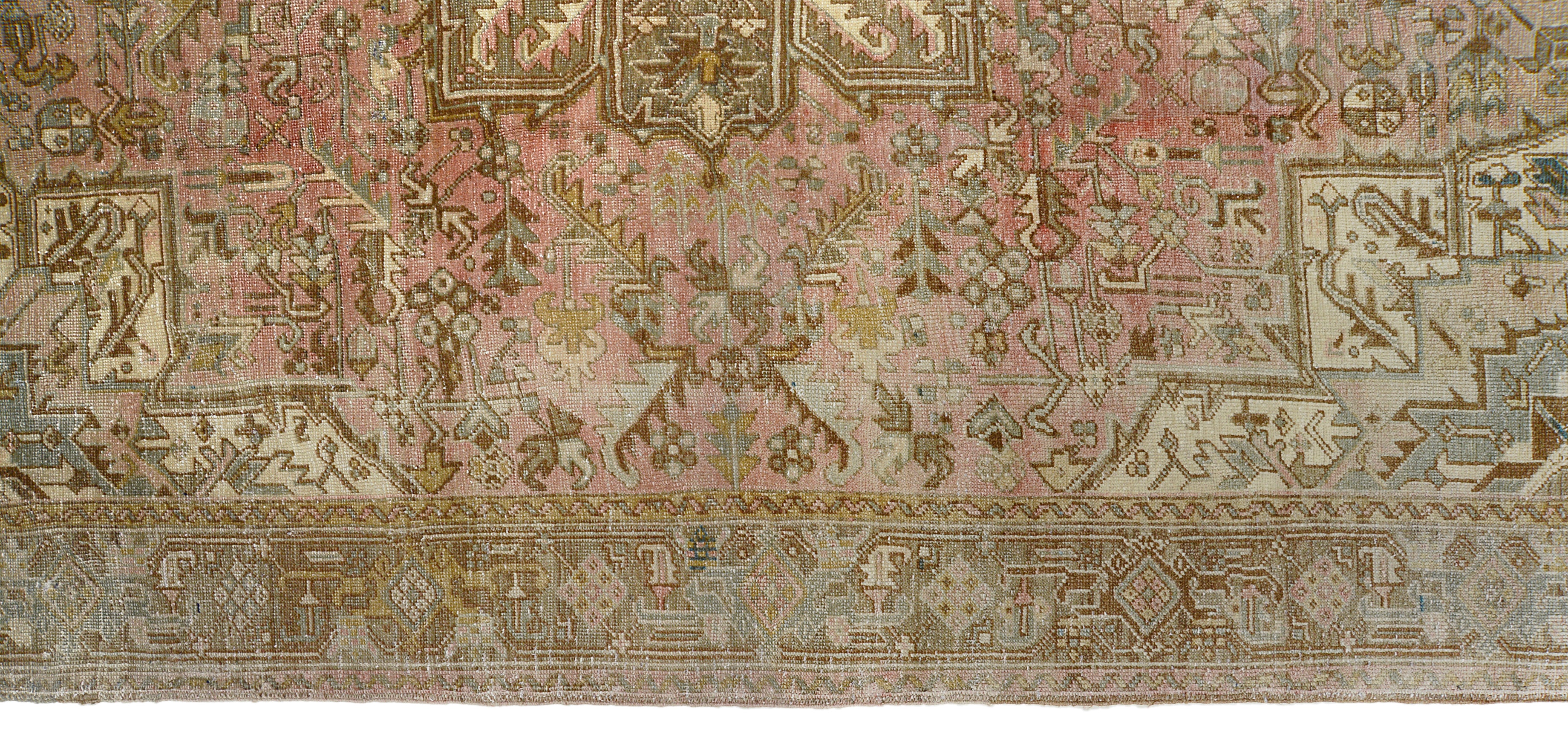 Detail of vintage Persian Heriz carpet showing wool texture, geometric motifs and natural colour variation from age and use
