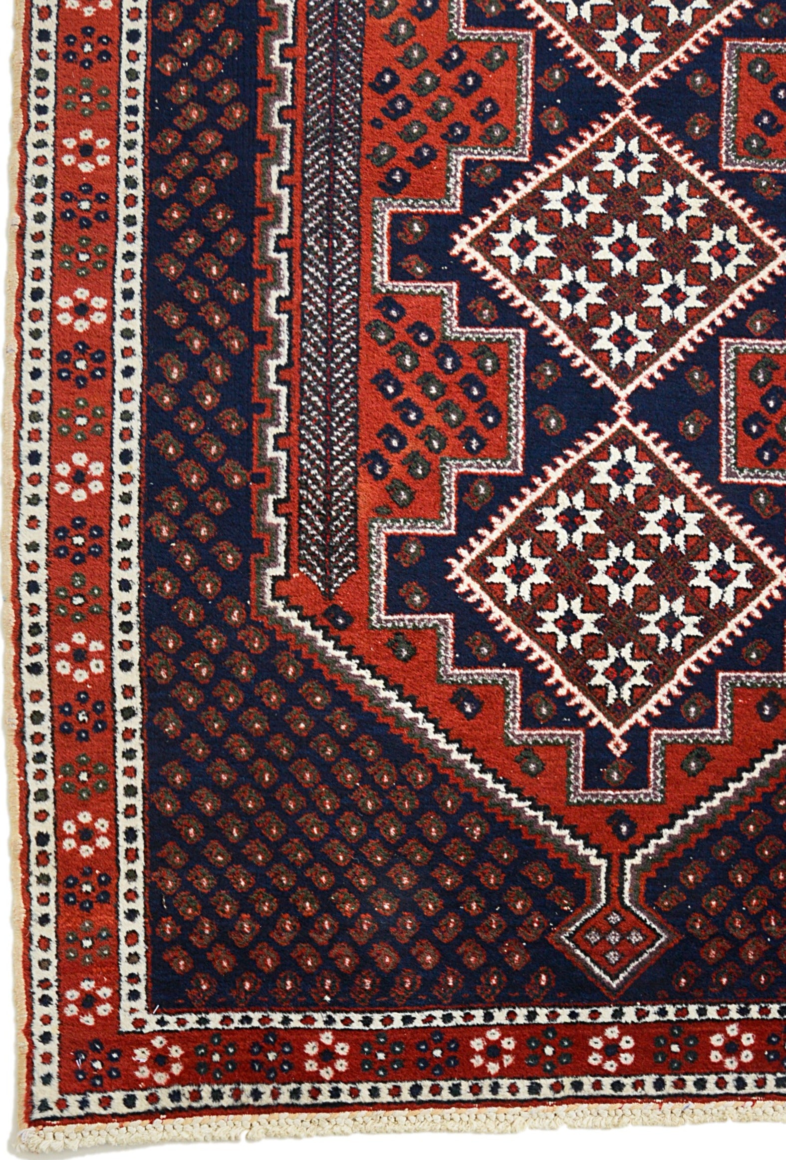 Corner view of an antique Persian Afshar rug showing bold geometric border and field details
