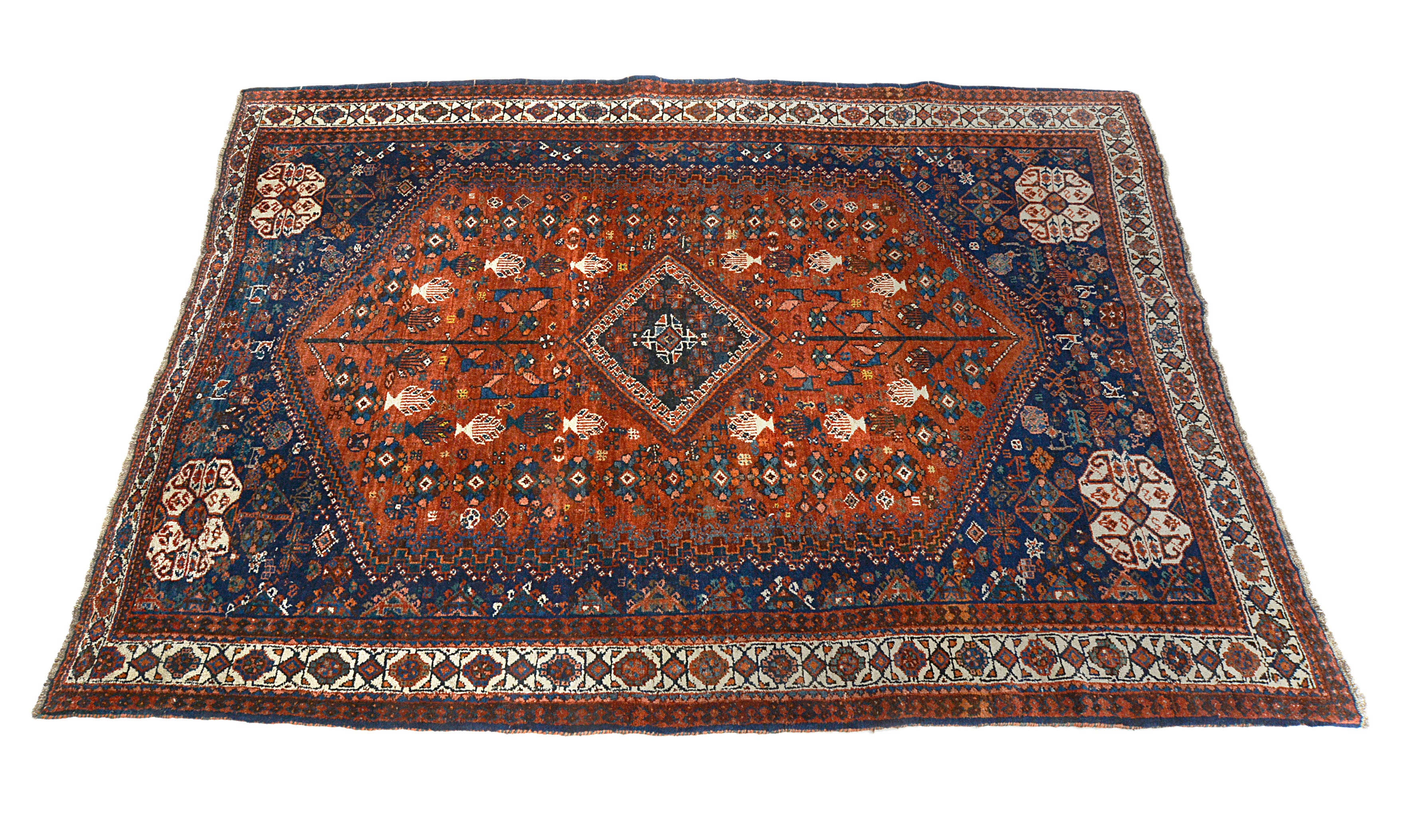 Angled view of an antique Persian Qashqai carpet highlighting overall composition
