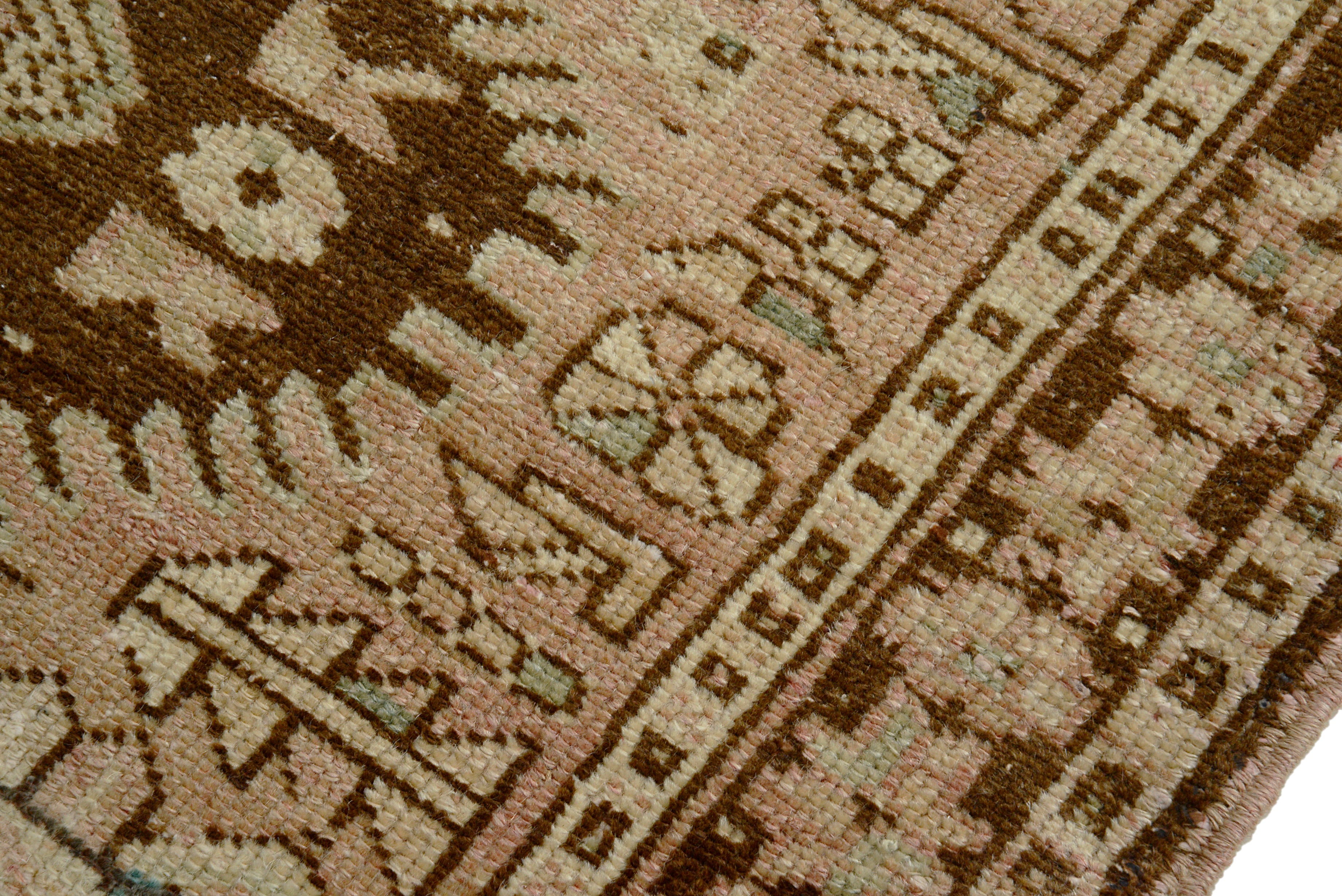 Close-up of a muted colour handmade Persian Heriz Runner with geometric designs.