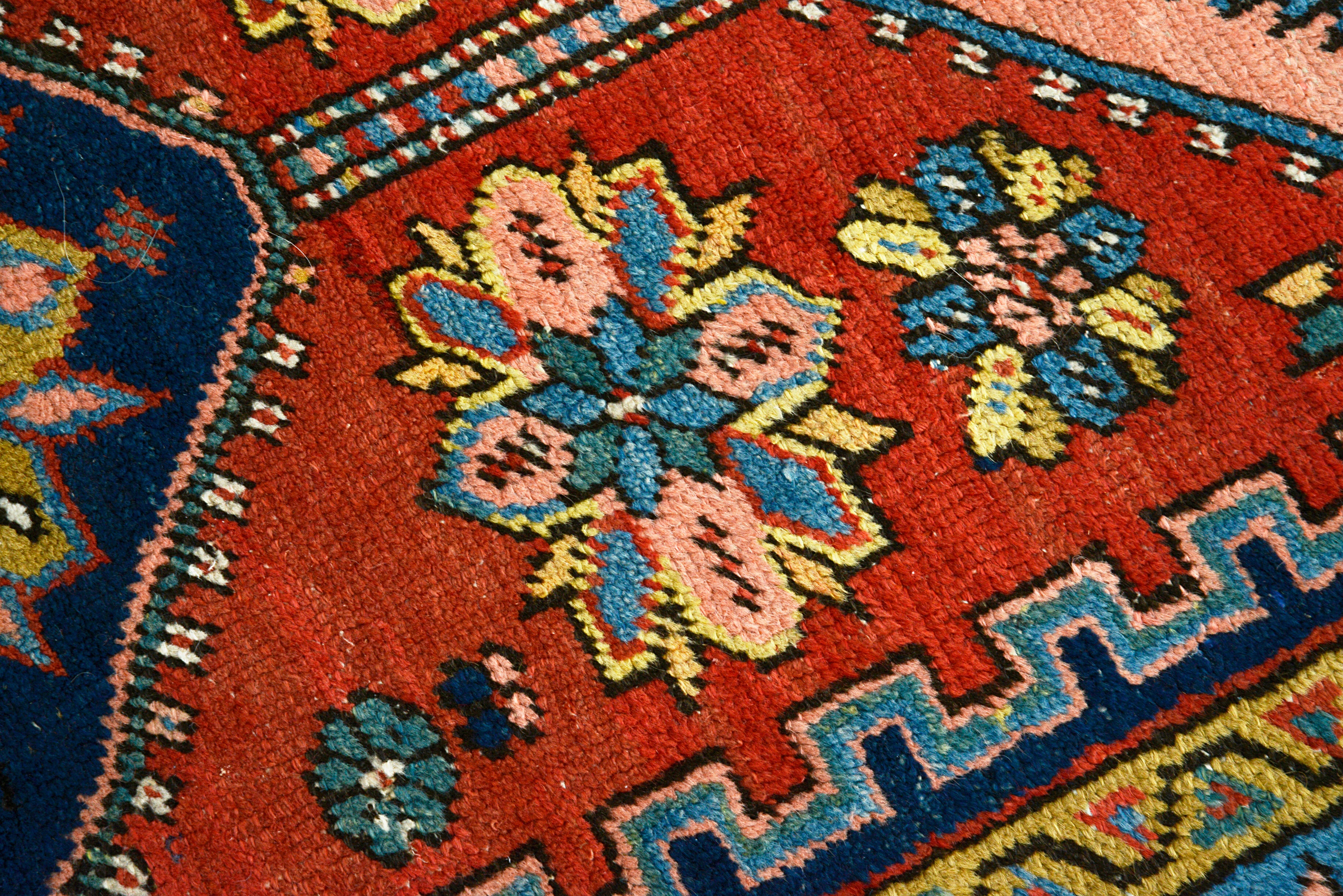 Hand-knotted wool texture of an antique Persian Heriz runner
