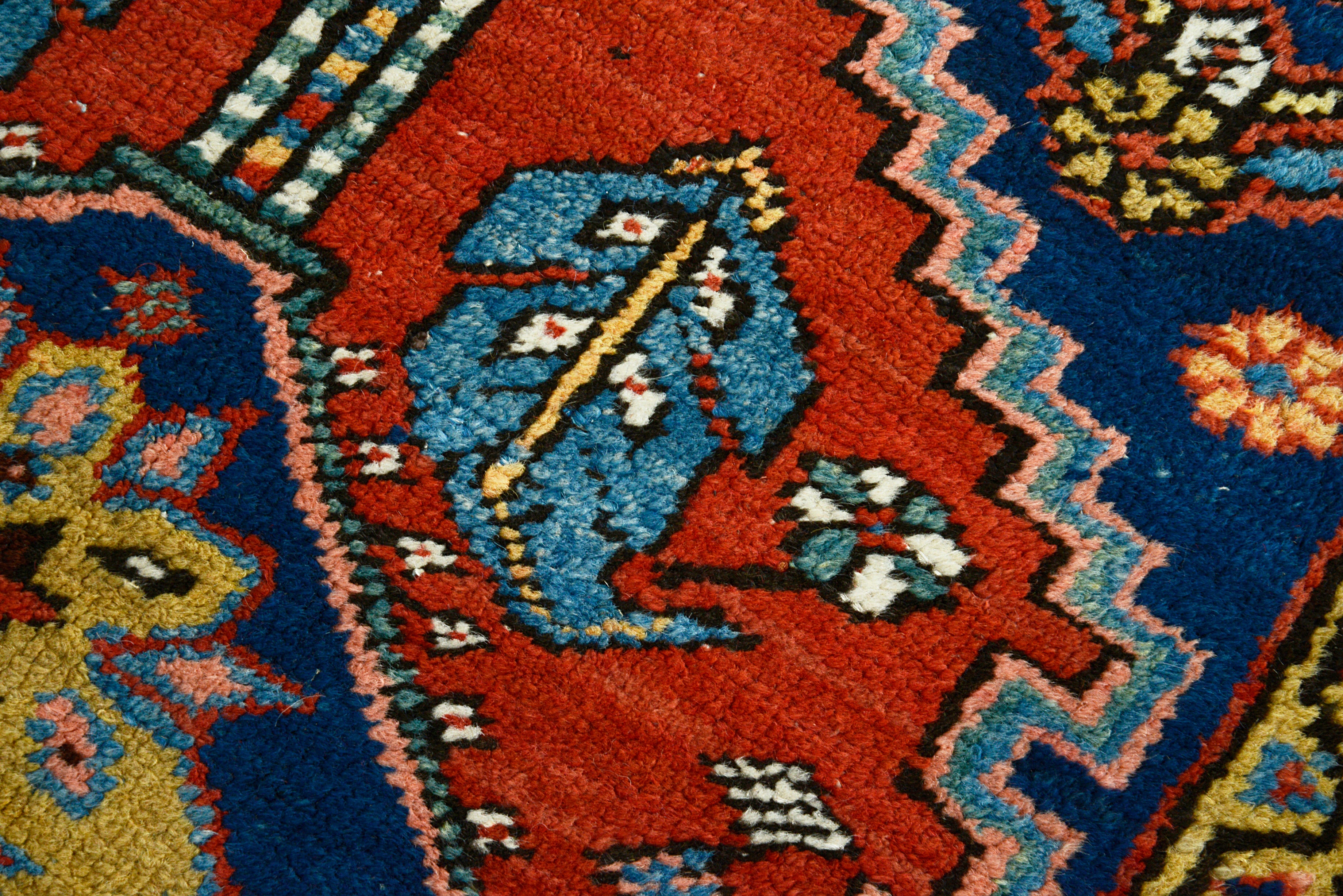 Hand-knotted wool texture of an antique Persian Heriz rug
