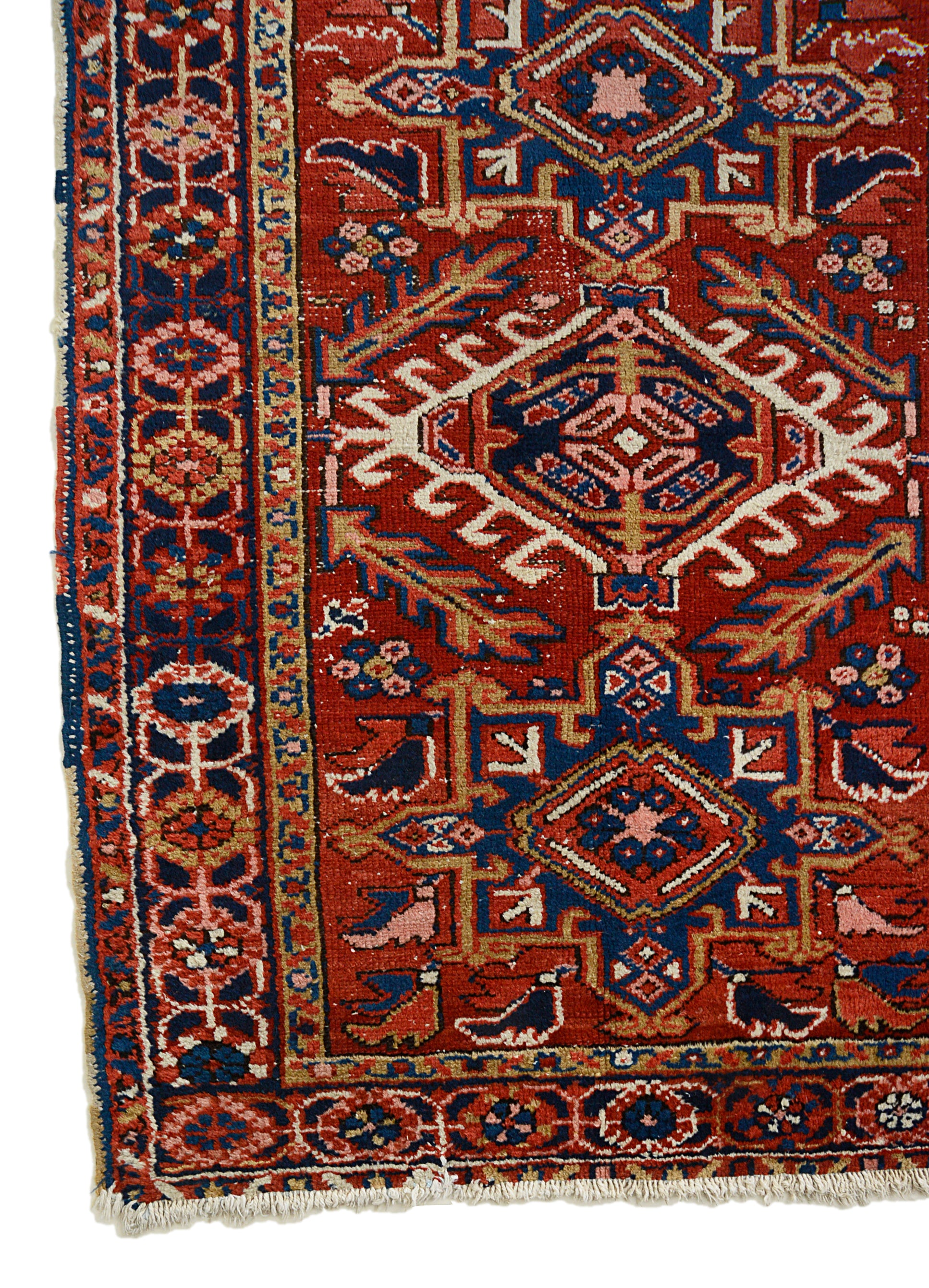 Corner view of an antique Persian Heriz rug showing bold border and field details