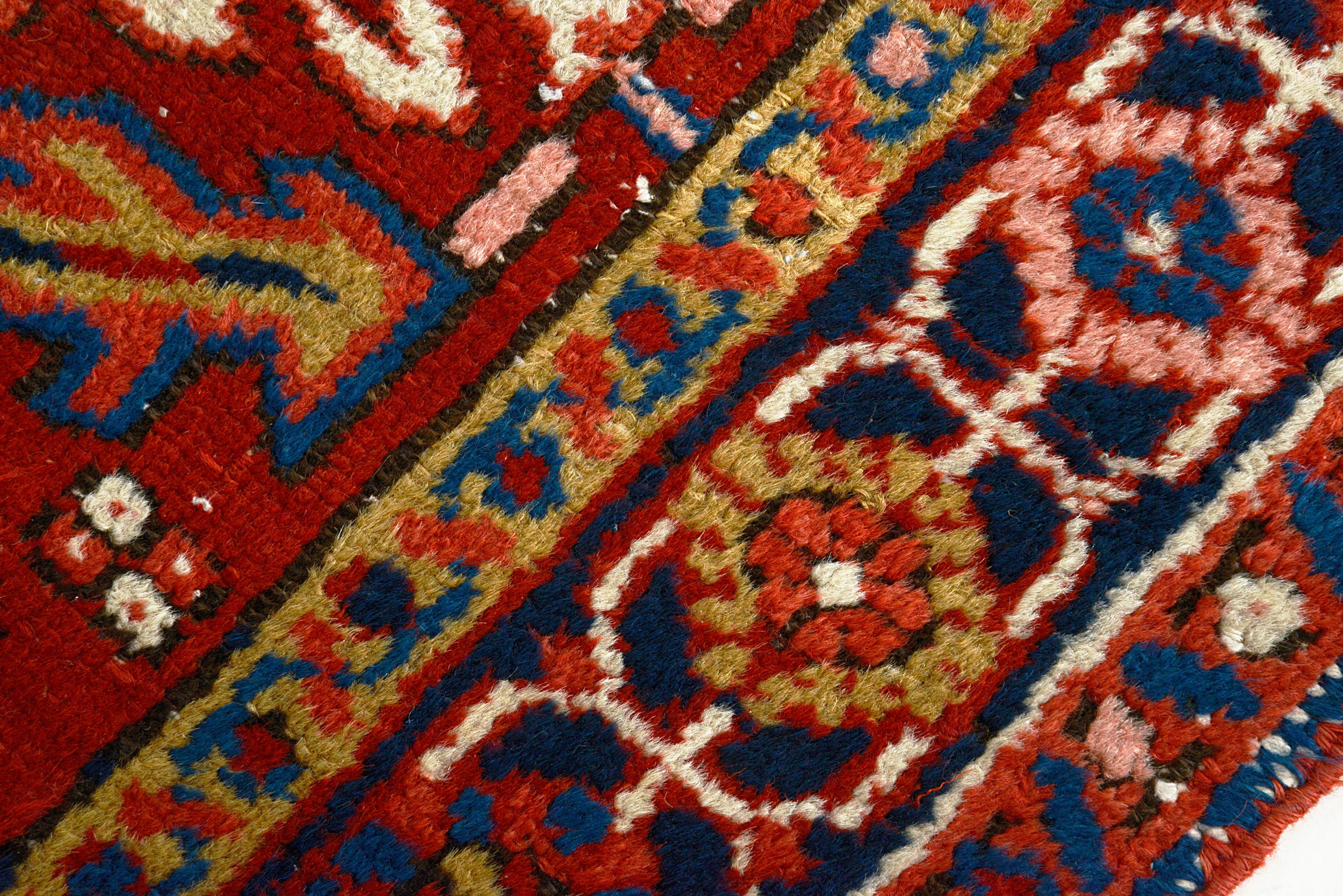 Close-up of a patterned Hand Knotted Persian Heriz rug with intricate designs.