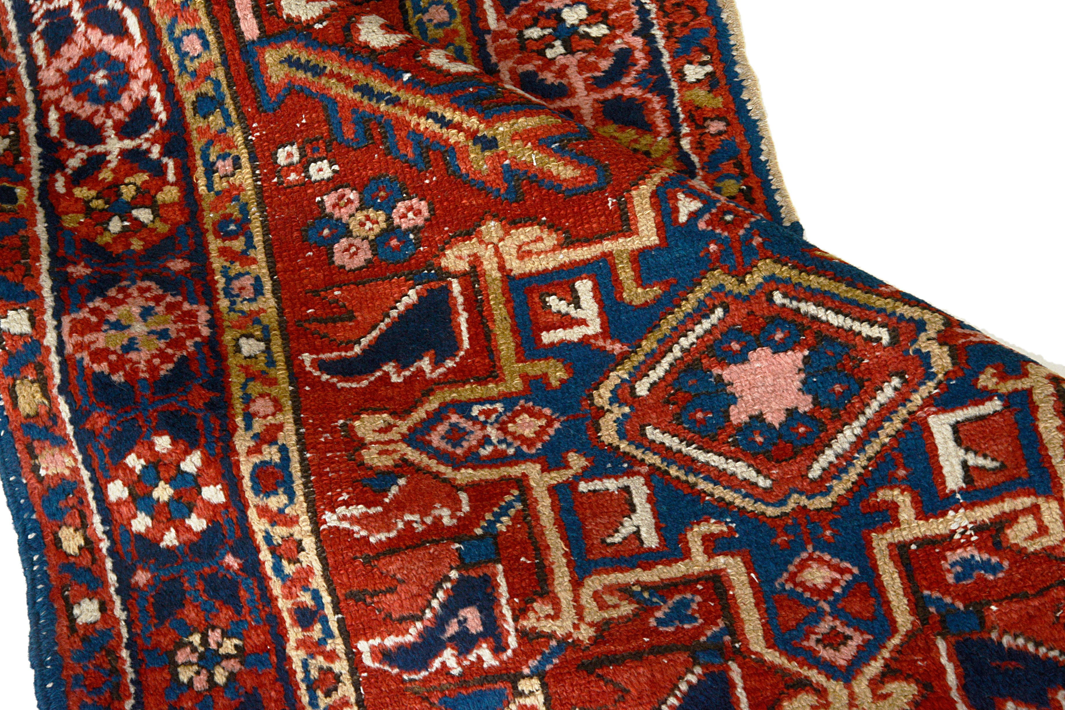 Hand-knotted wool texture of an antique Persian Heriz rug
