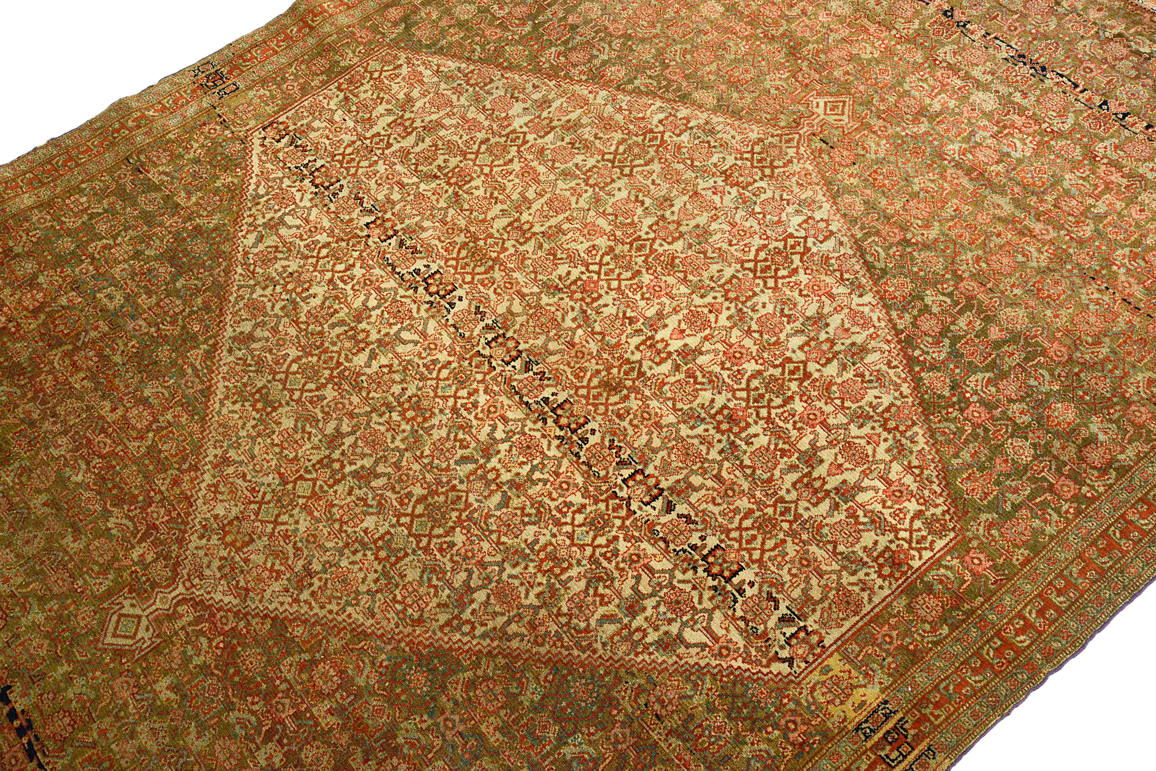 Close-up of the central field design on an antique Persian Senneh rug