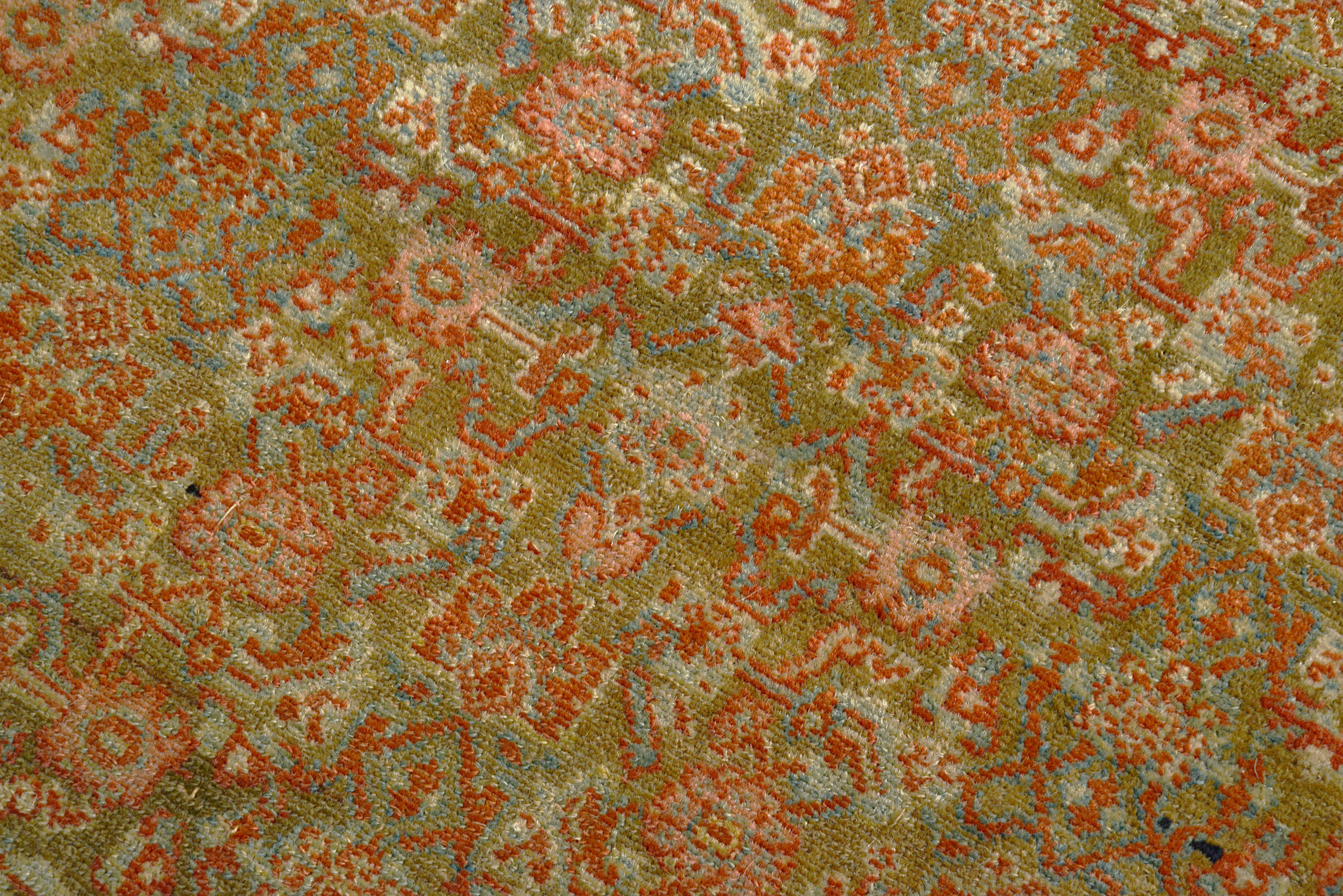 Close-up of a patterned hand knotted rug  with red and green colors