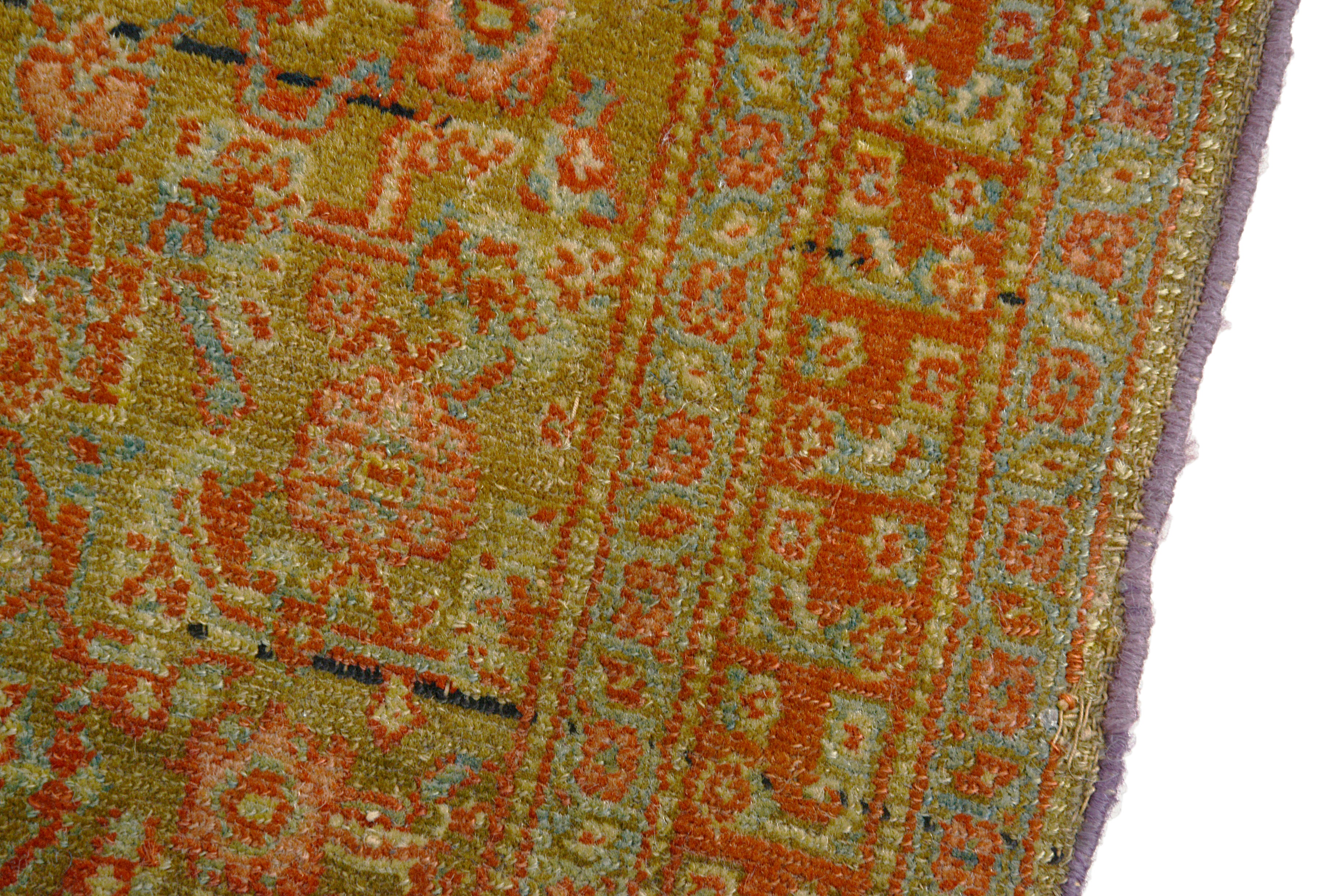 Fine hand-knotted wool texture of an antique Persian Senneh rug