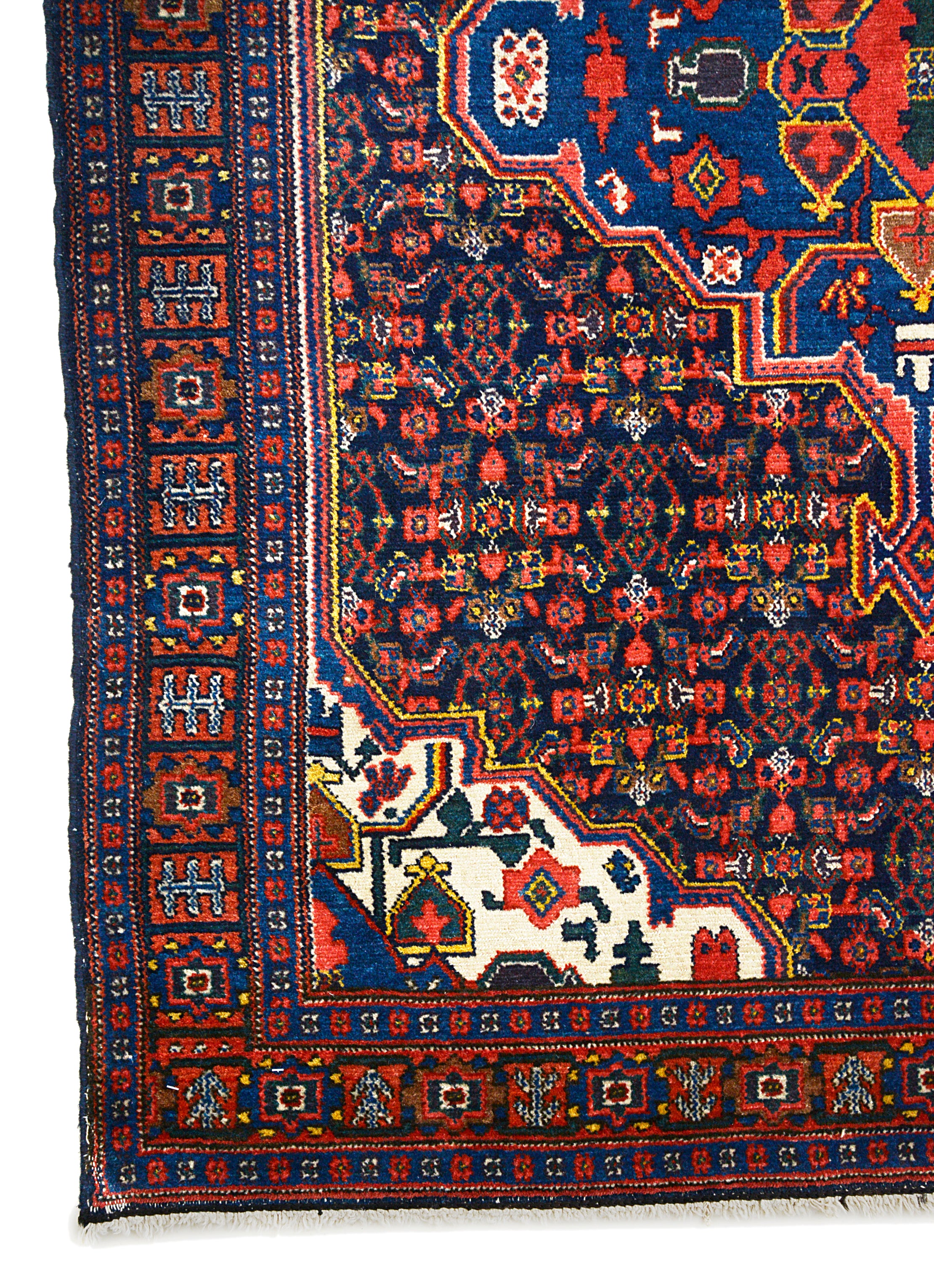 Corner view of an antique Persian Senneh rug showing fine border and field details