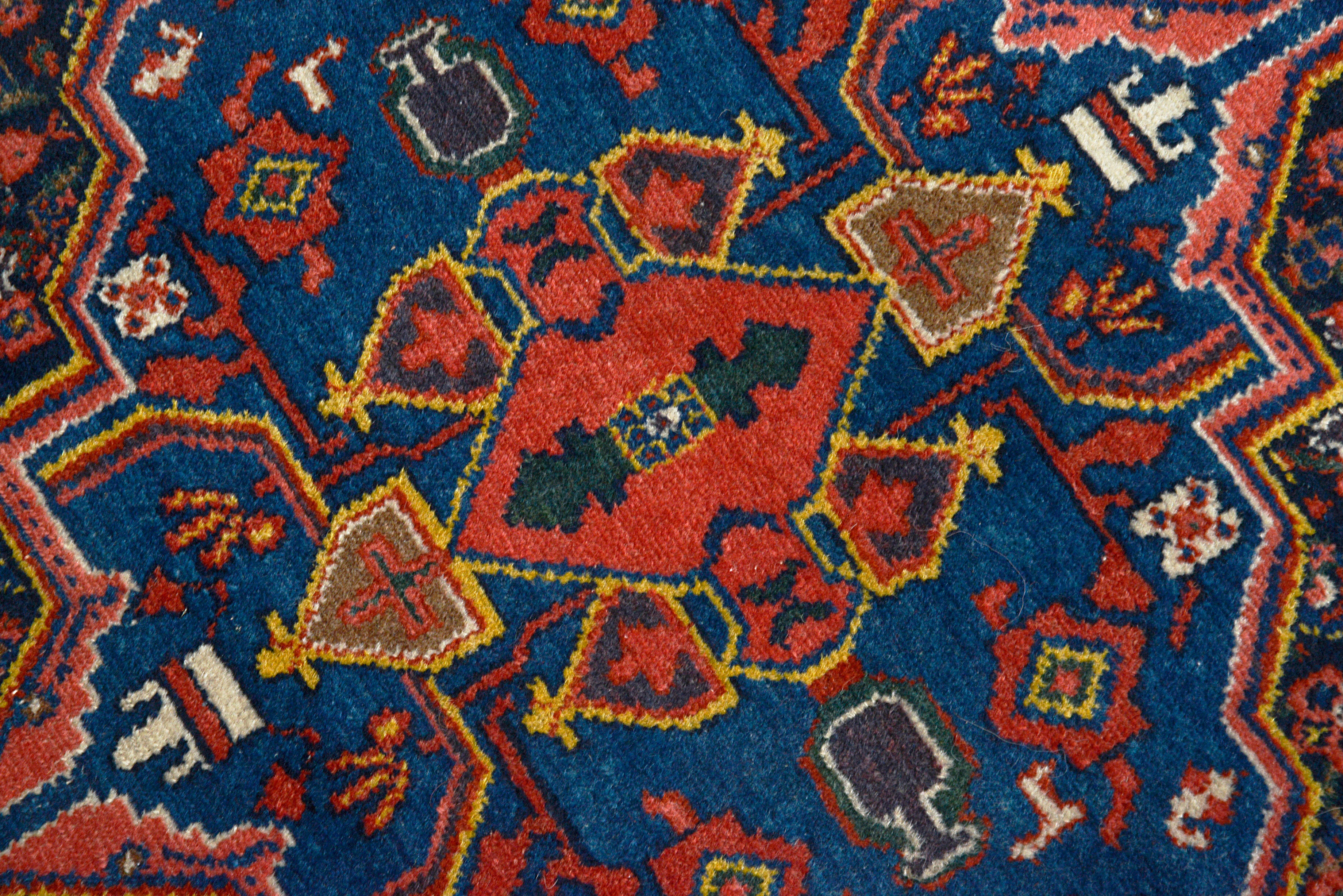 Close-up of the central field design on an antique Persian Senneh rug