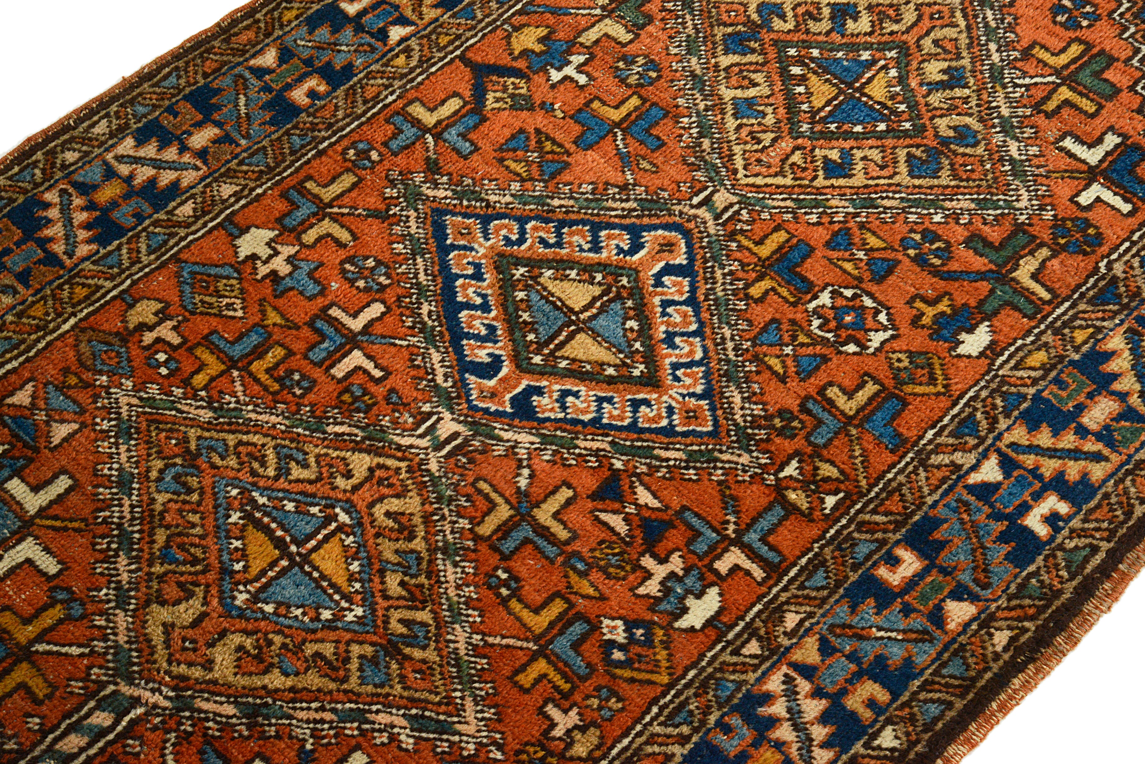 Close-up of a handmade Heriz rug with geometric designs.