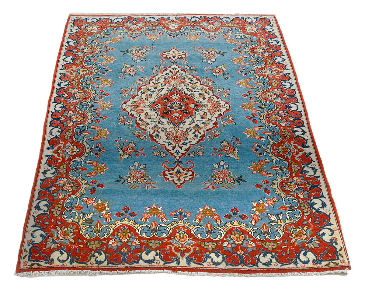 Full view of antique Persian Qom rug with central medallion and floral design