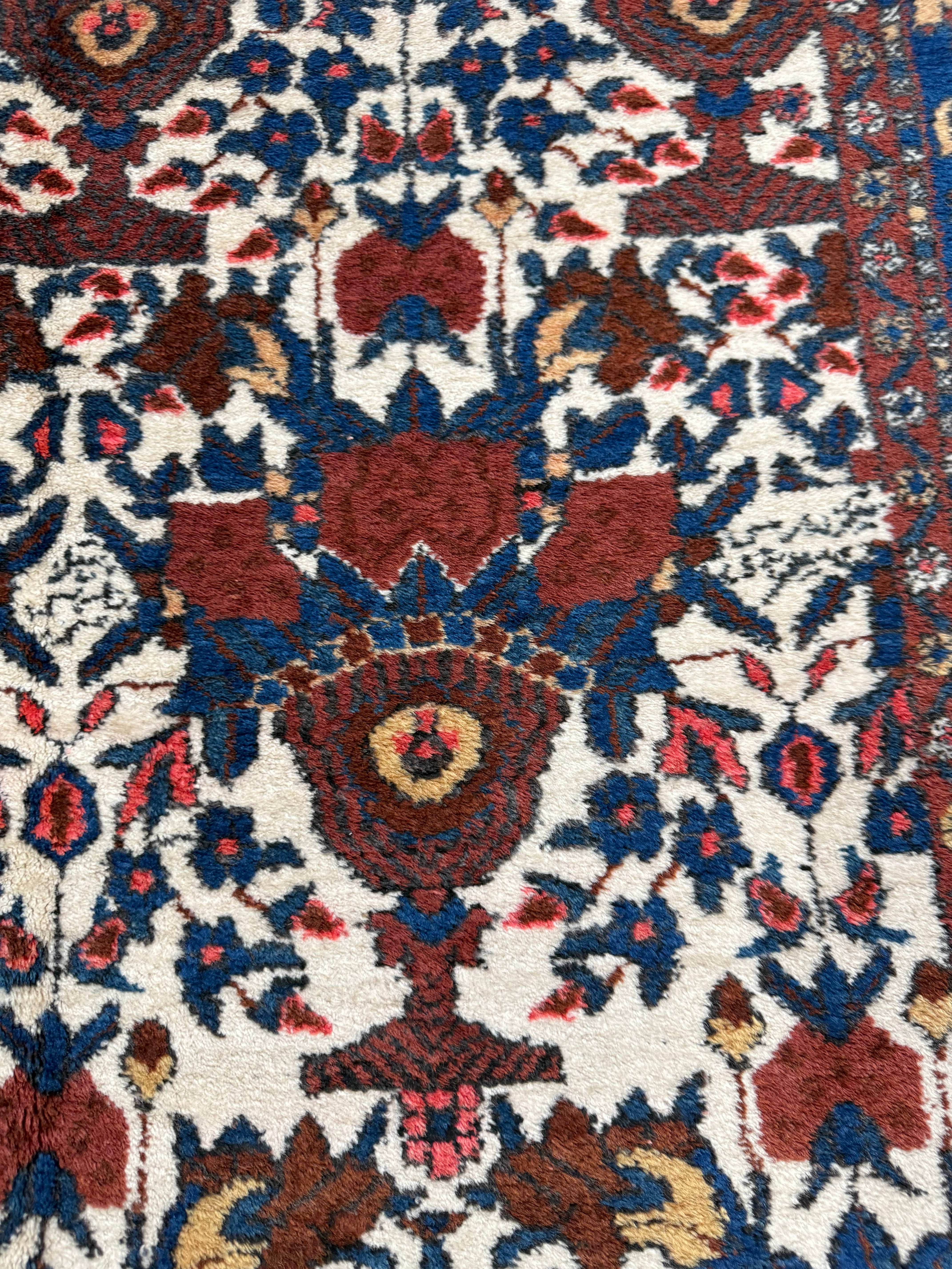 Close-up of hand-knotted wool texture on antique Persian Afshar rug
