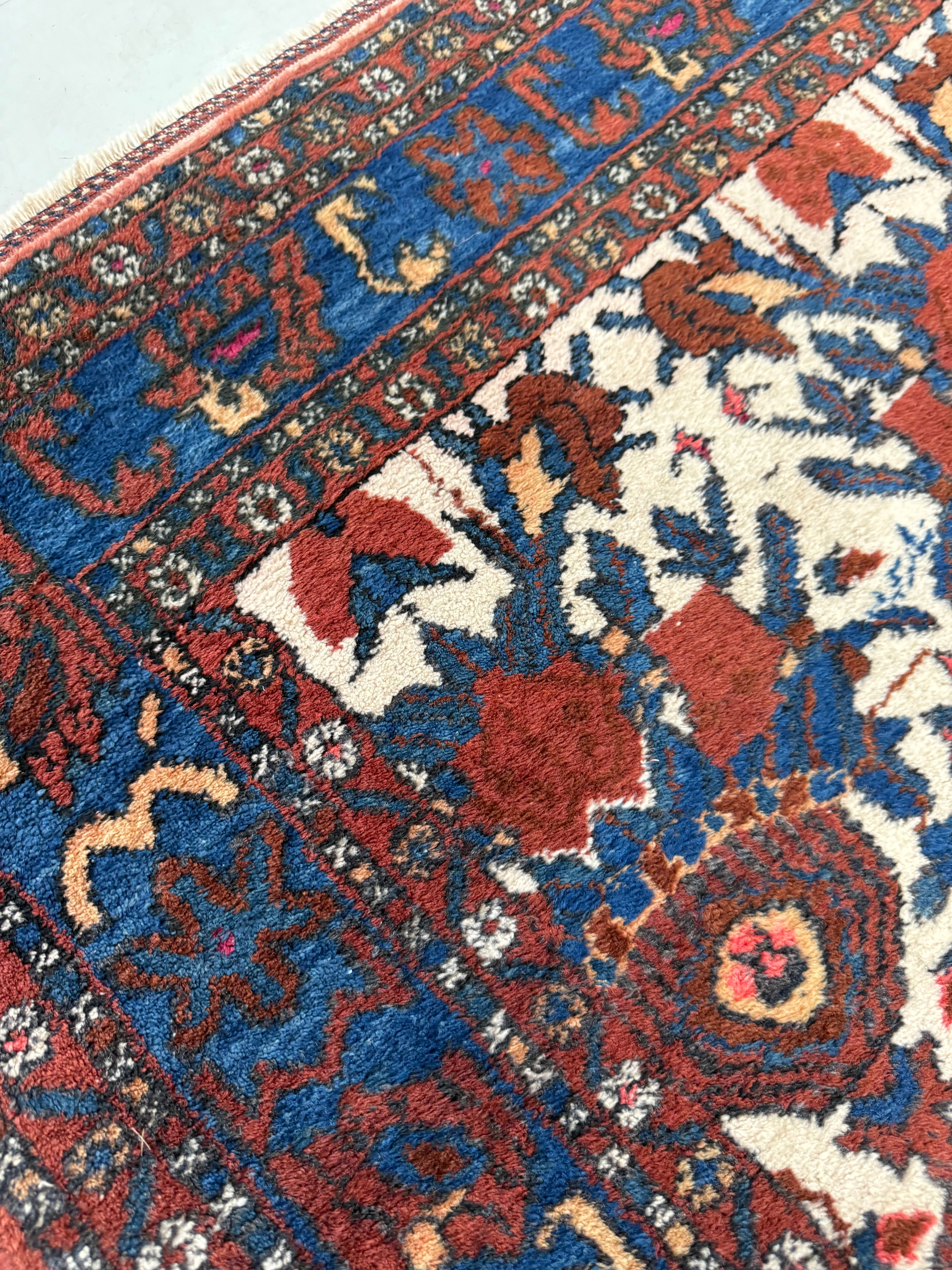 Close-up showing rich colours and tribal drawing on antique Persian Afshar rug
