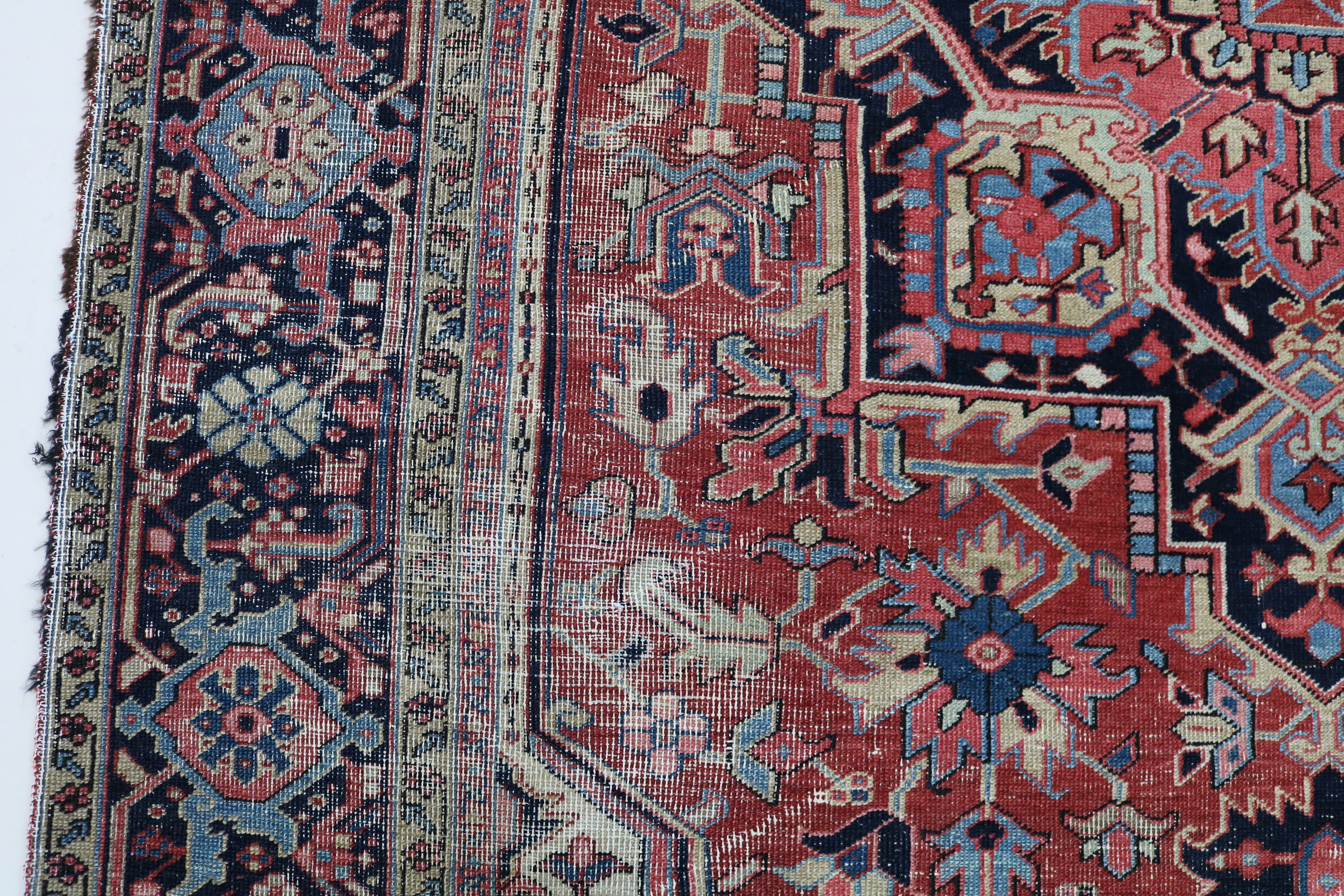 Close-up of hand-knotted wool texture on fine antique Persian Heriz carpet
