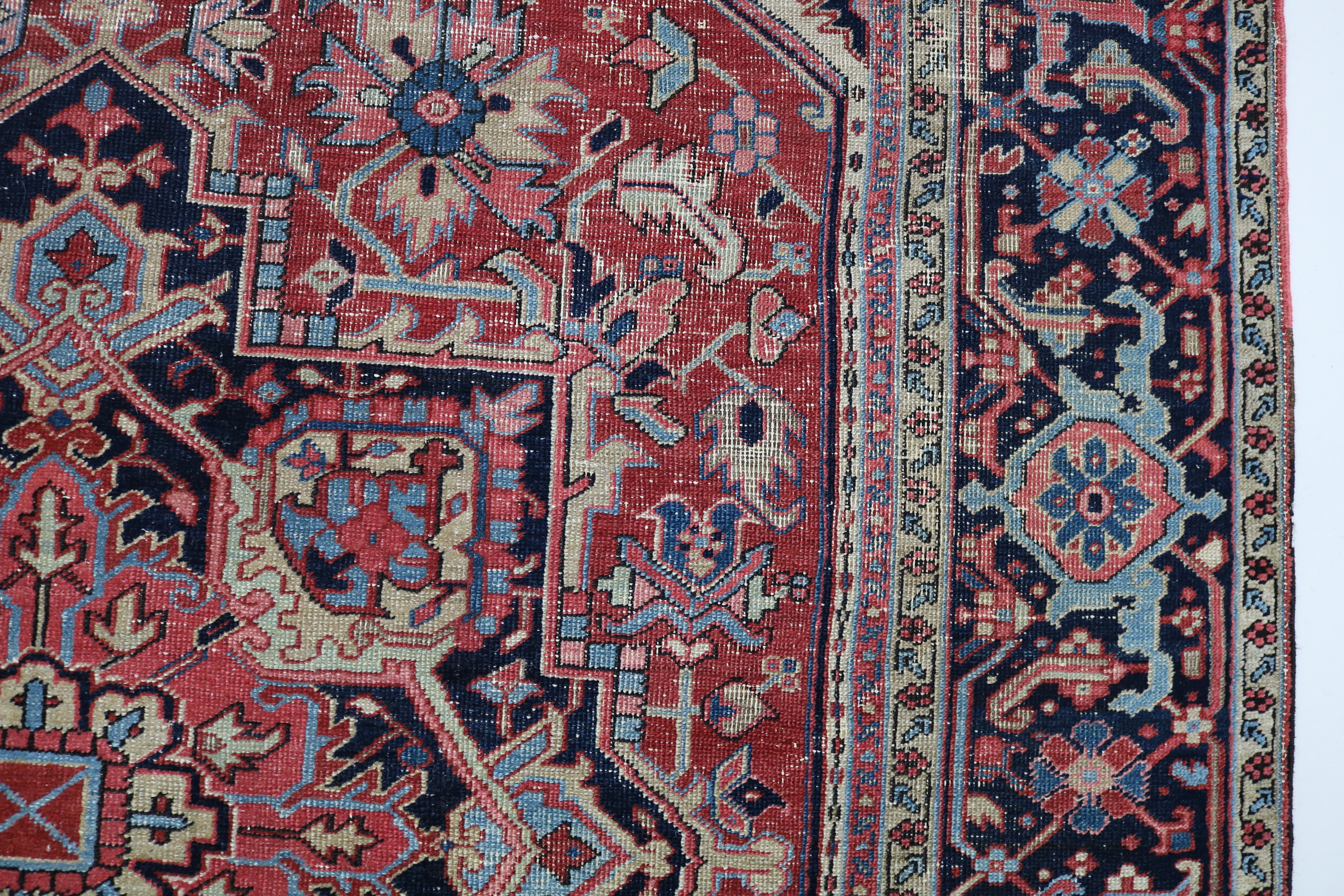 Close-up of hand-knotted wool texture on fine antique Persian Heriz carpet
