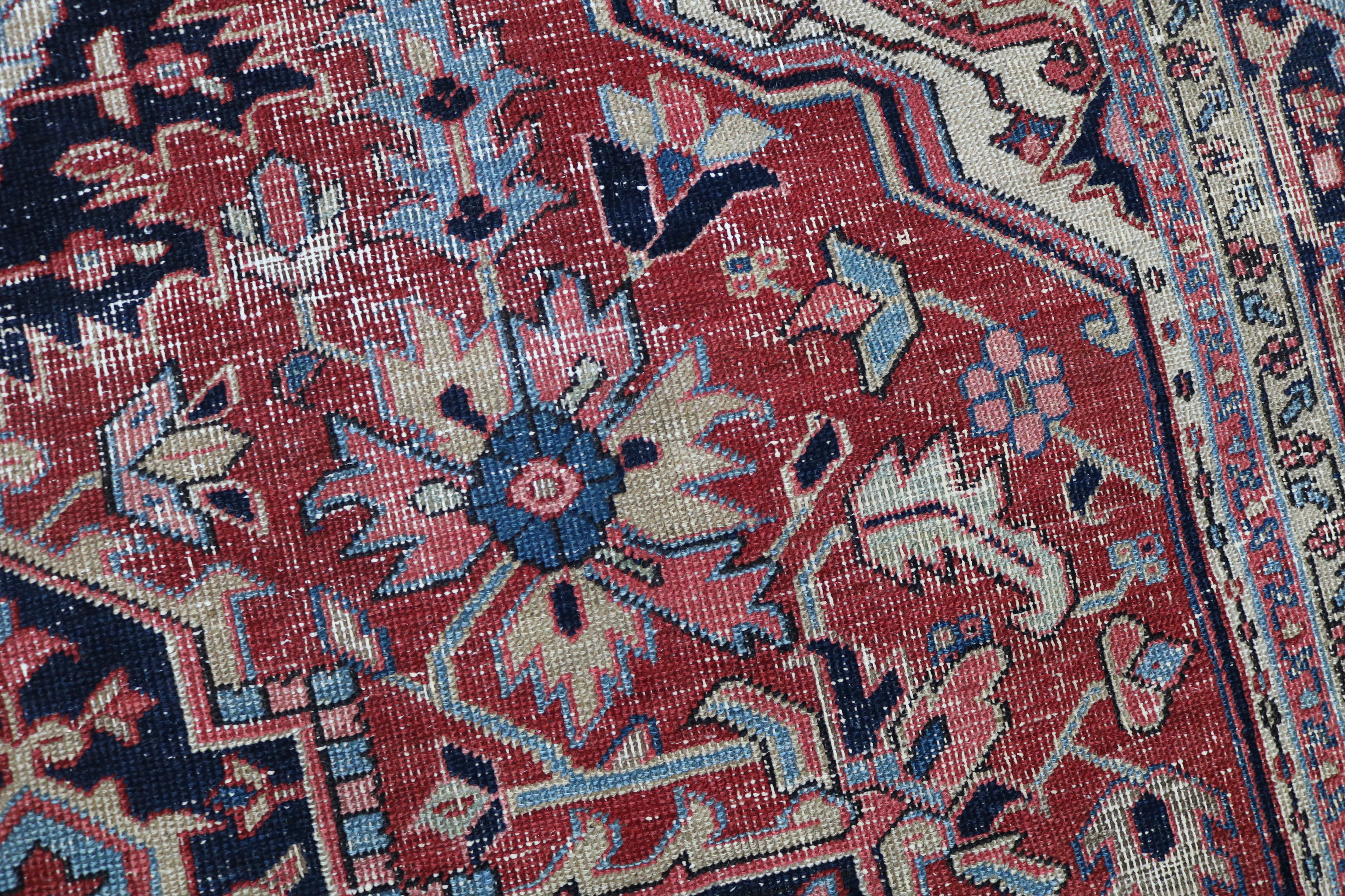 Close-up of hand-knotted wool texture on fine antique Persian Heriz carpet
