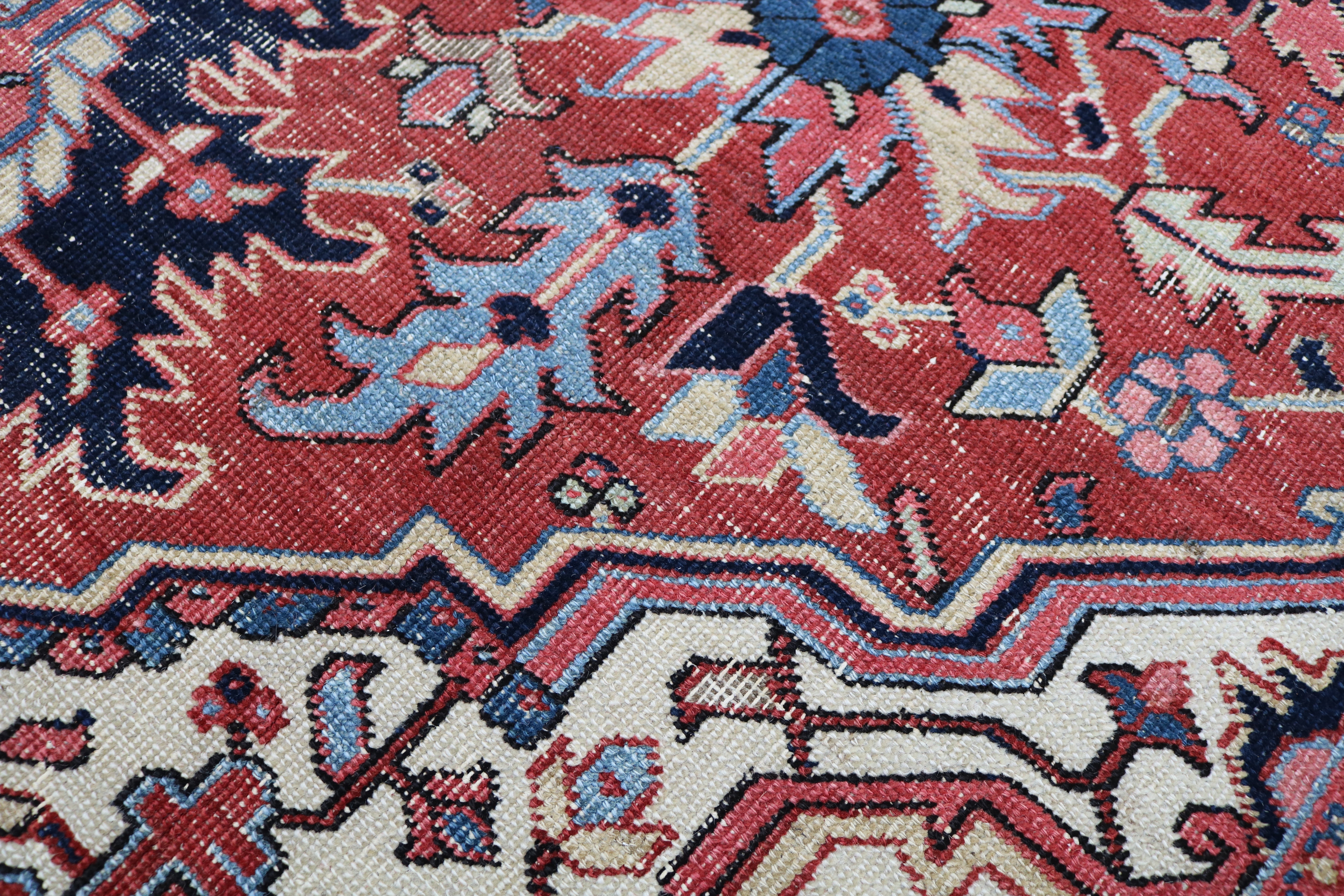 Close-up of hand-knotted wool texture on fine antique Persian Heriz carpet
