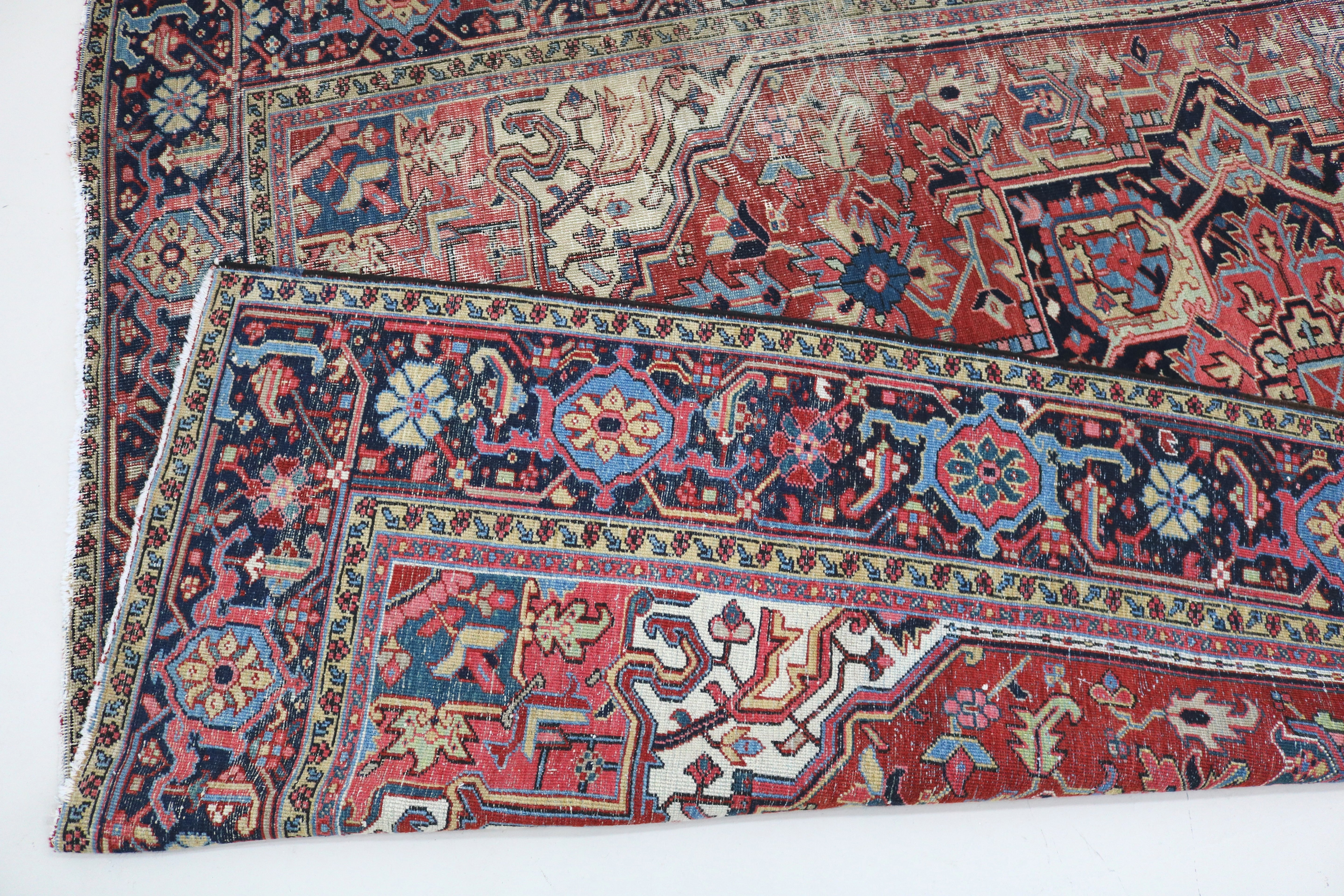Close-up of hand-knotted wool texture on fine antique Persian Heriz carpet
