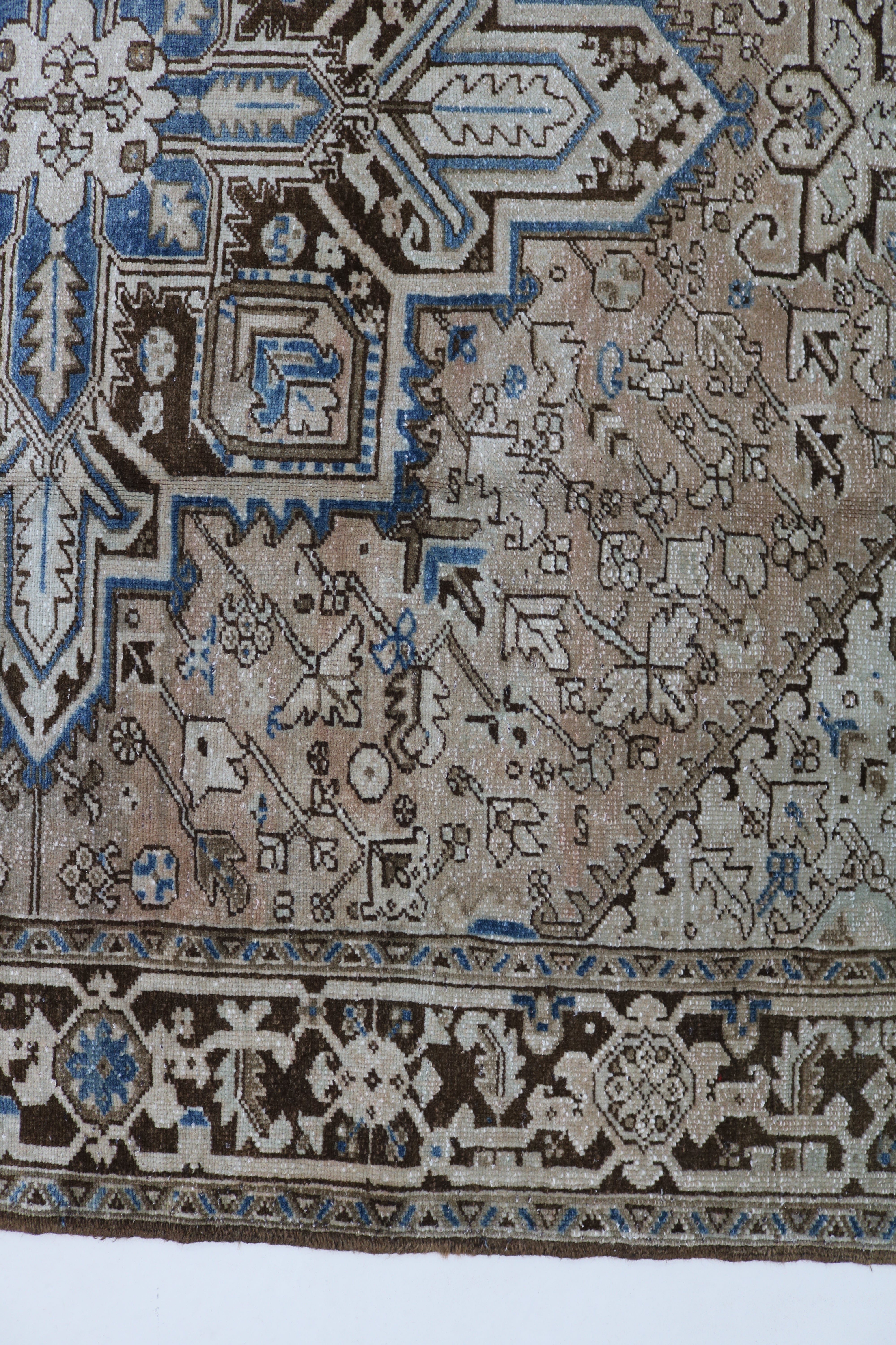 Close-up of hand-knotted wool texture on antique Persian Heriz carpet