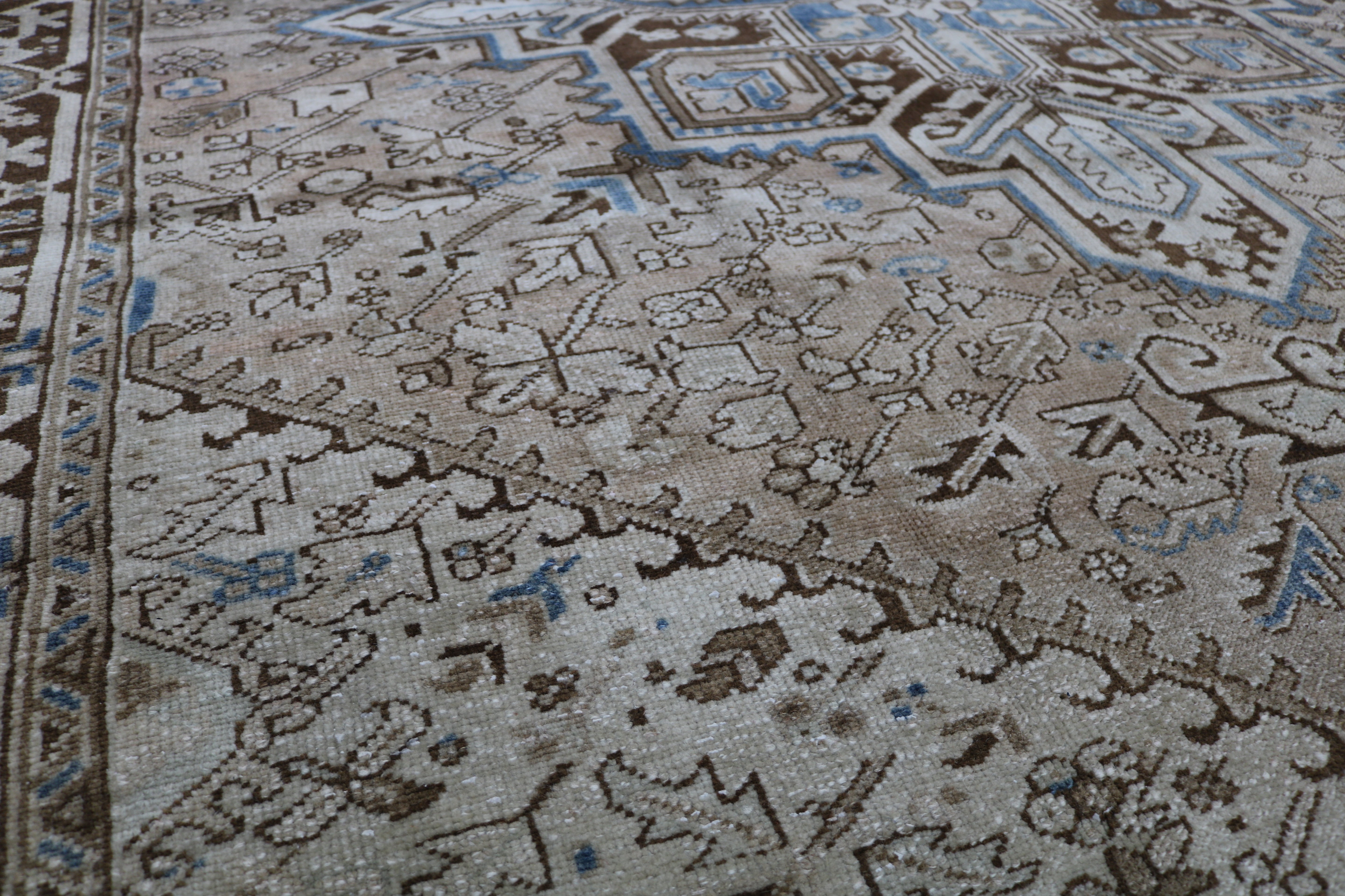 Close-up of hand-knotted wool texture on antique Persian Heriz carpet