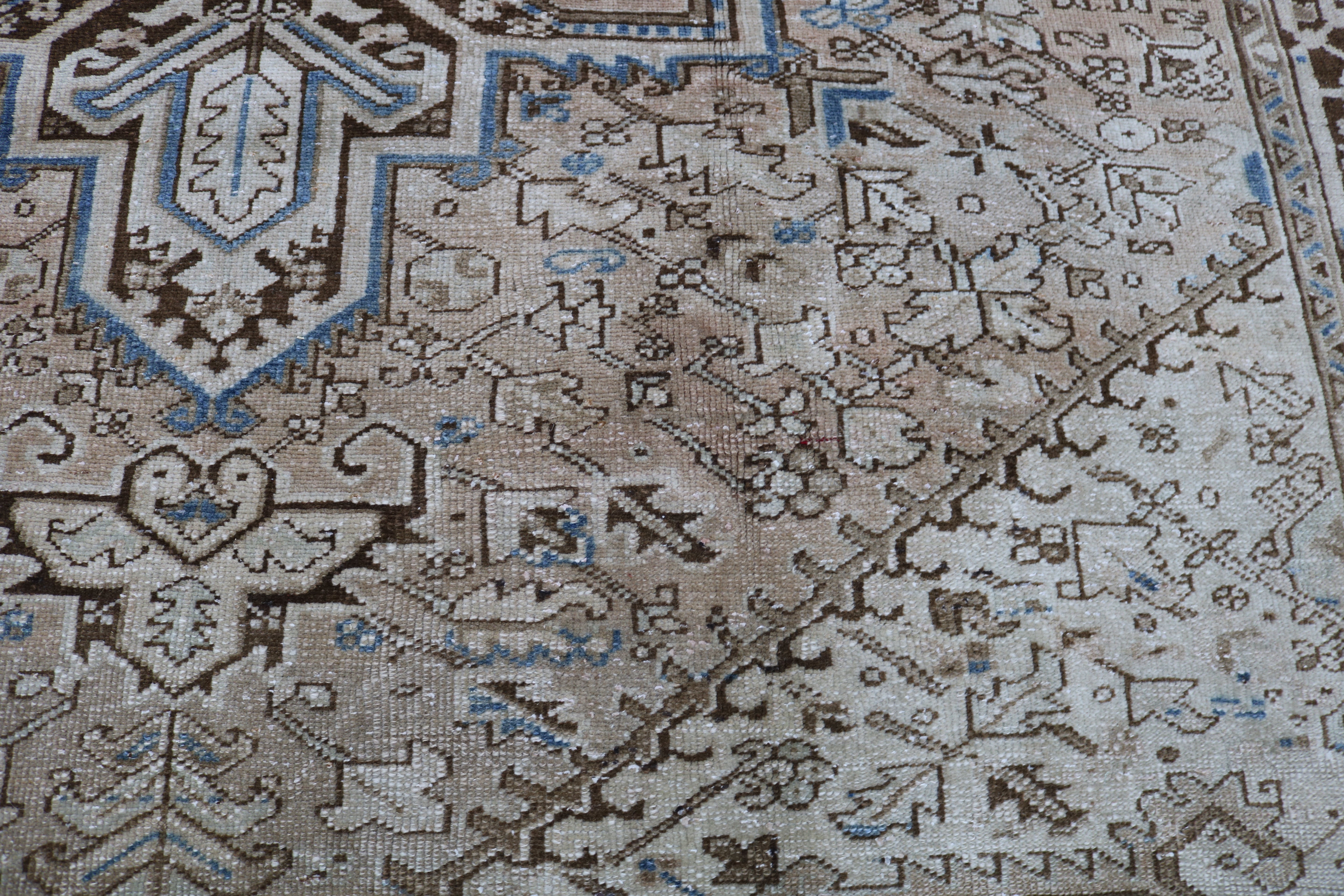 Close-up of hand-knotted wool texture on antique Persian Heriz carpet