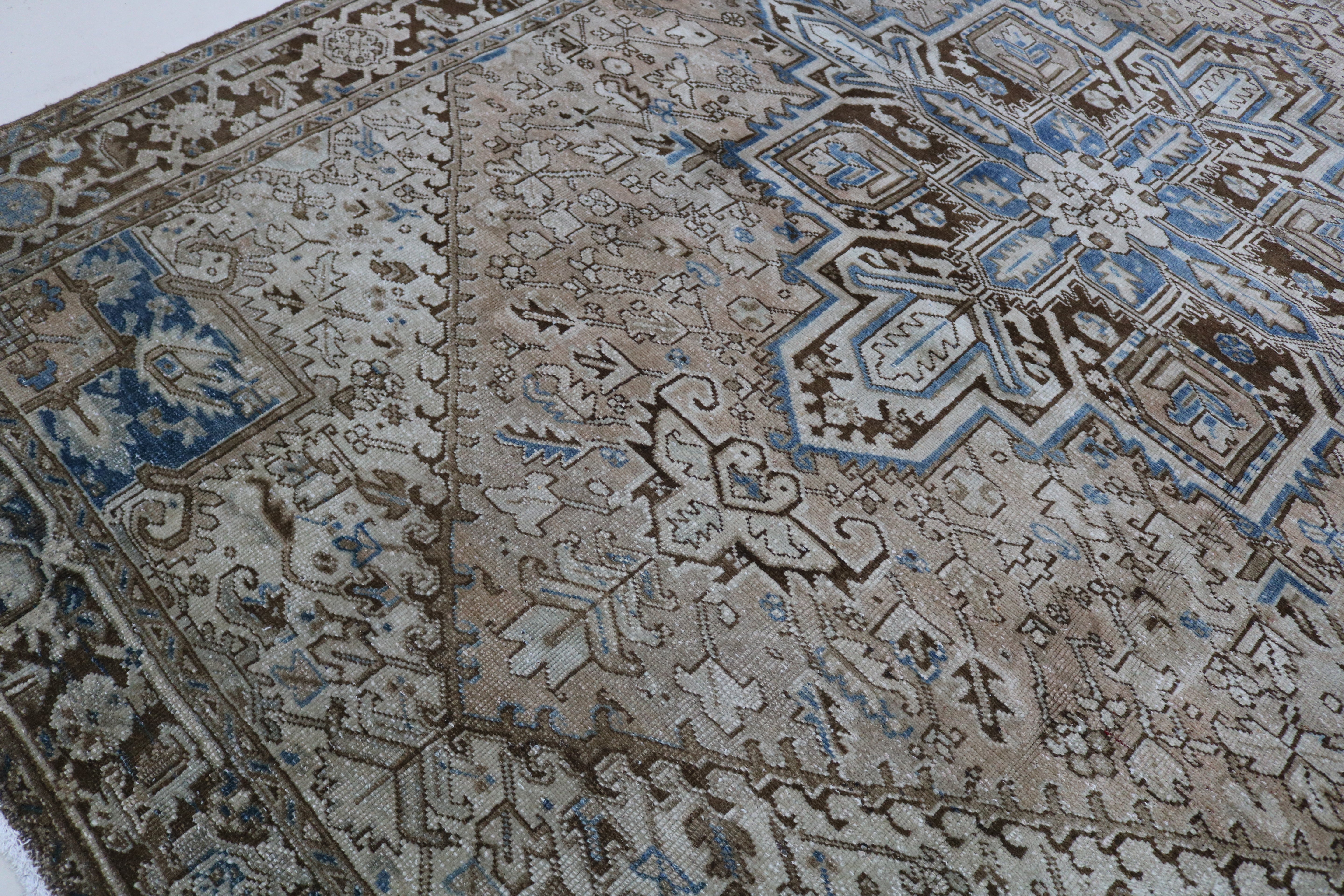 Close-up of hand-knotted wool texture on antique Persian Heriz carpet