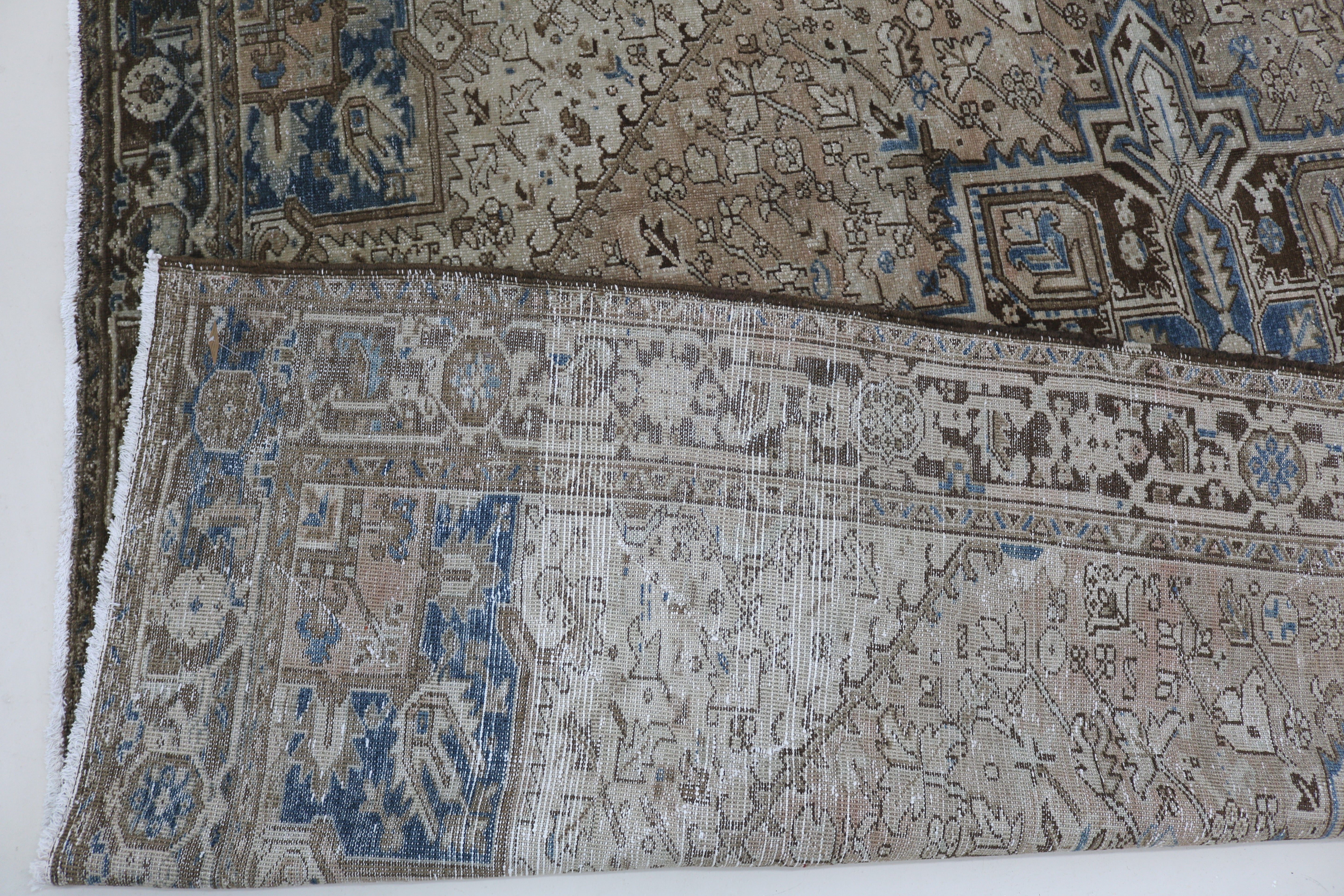 Close-up of hand-knotted wool texture on antique Persian Heriz carpet