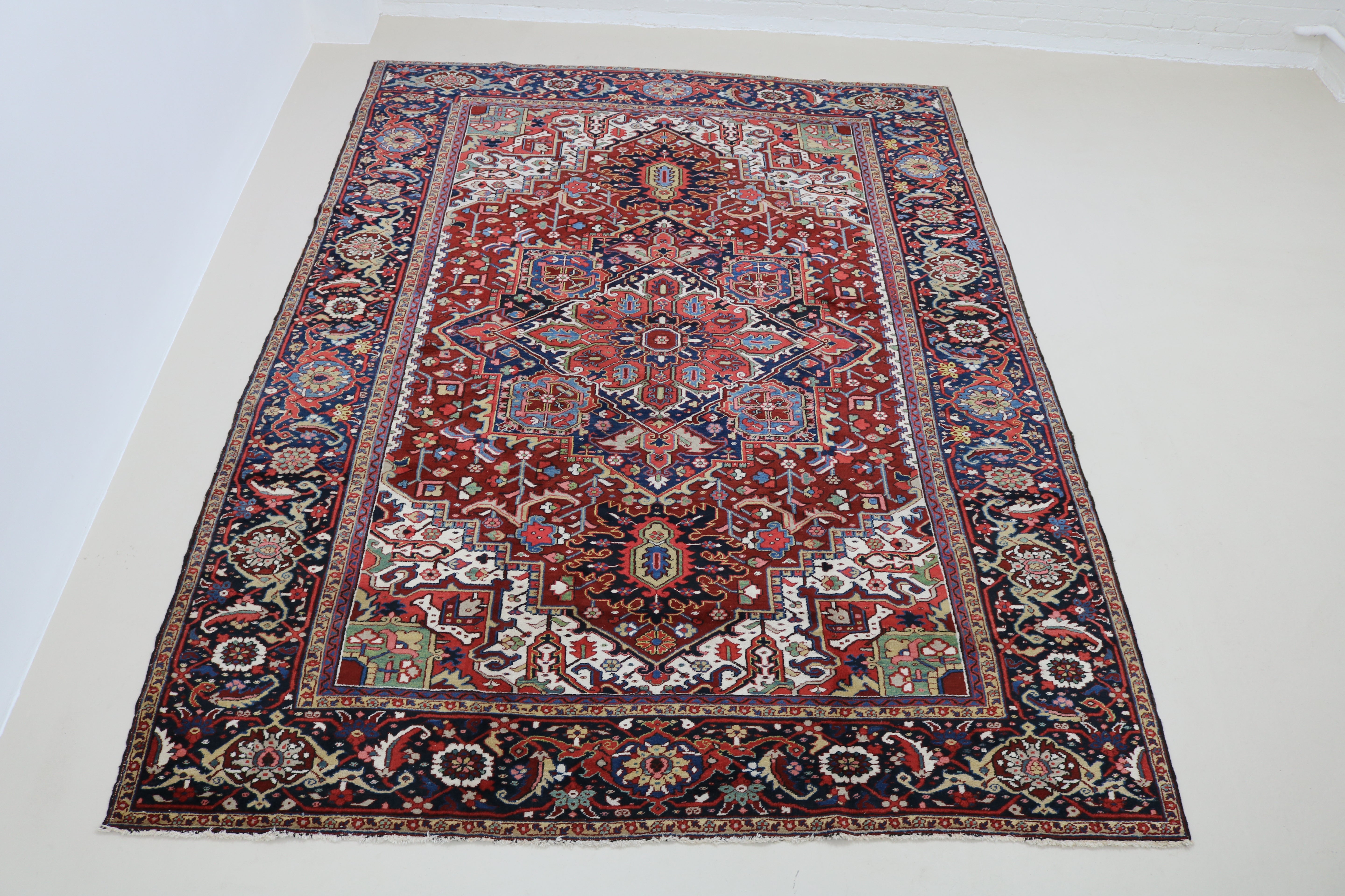 Full view of fine antique Persian Heriz carpet with well-balanced geometric field and borders
