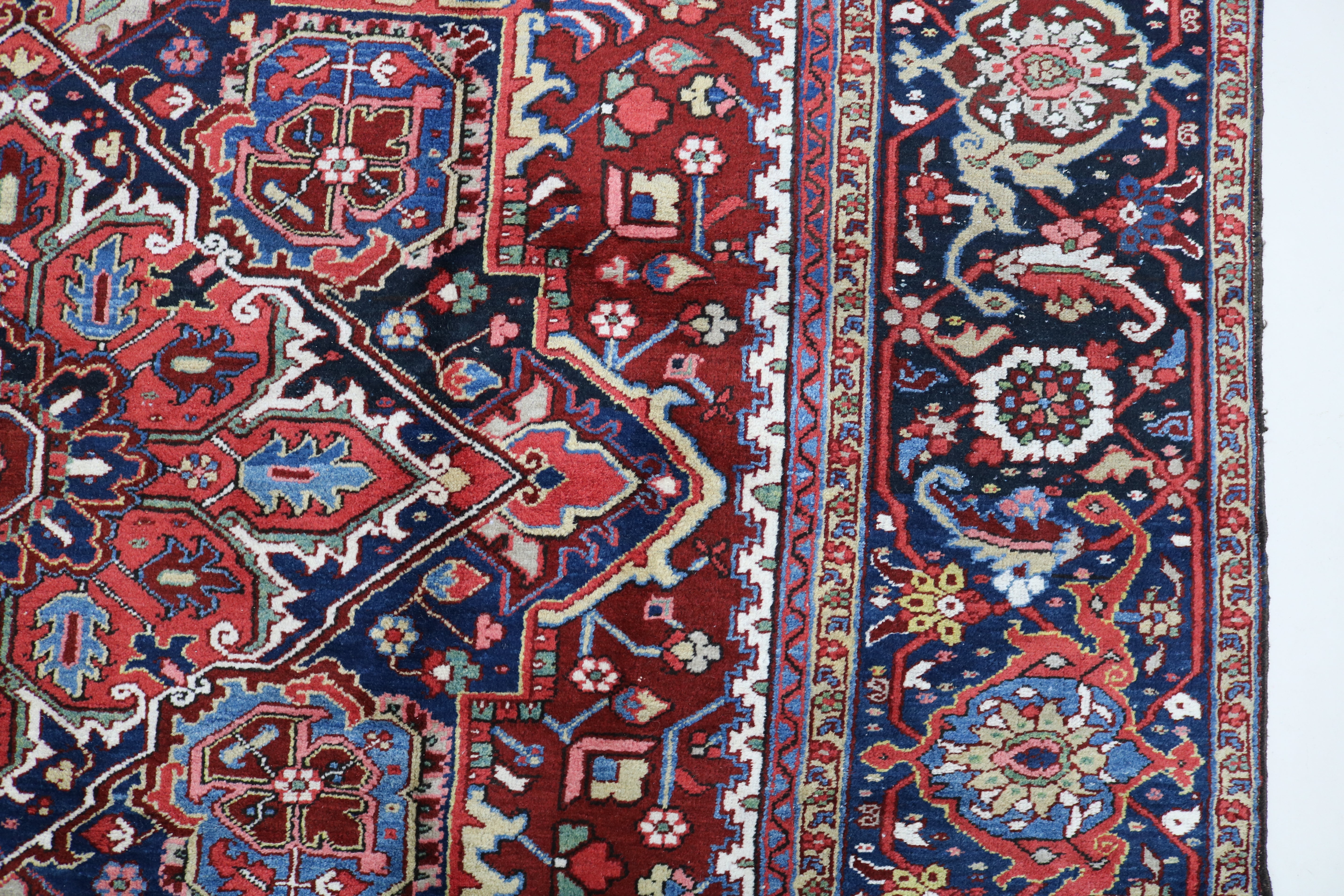 Close-up of hand-knotted wool texture on fine antique Persian Heriz carpet
