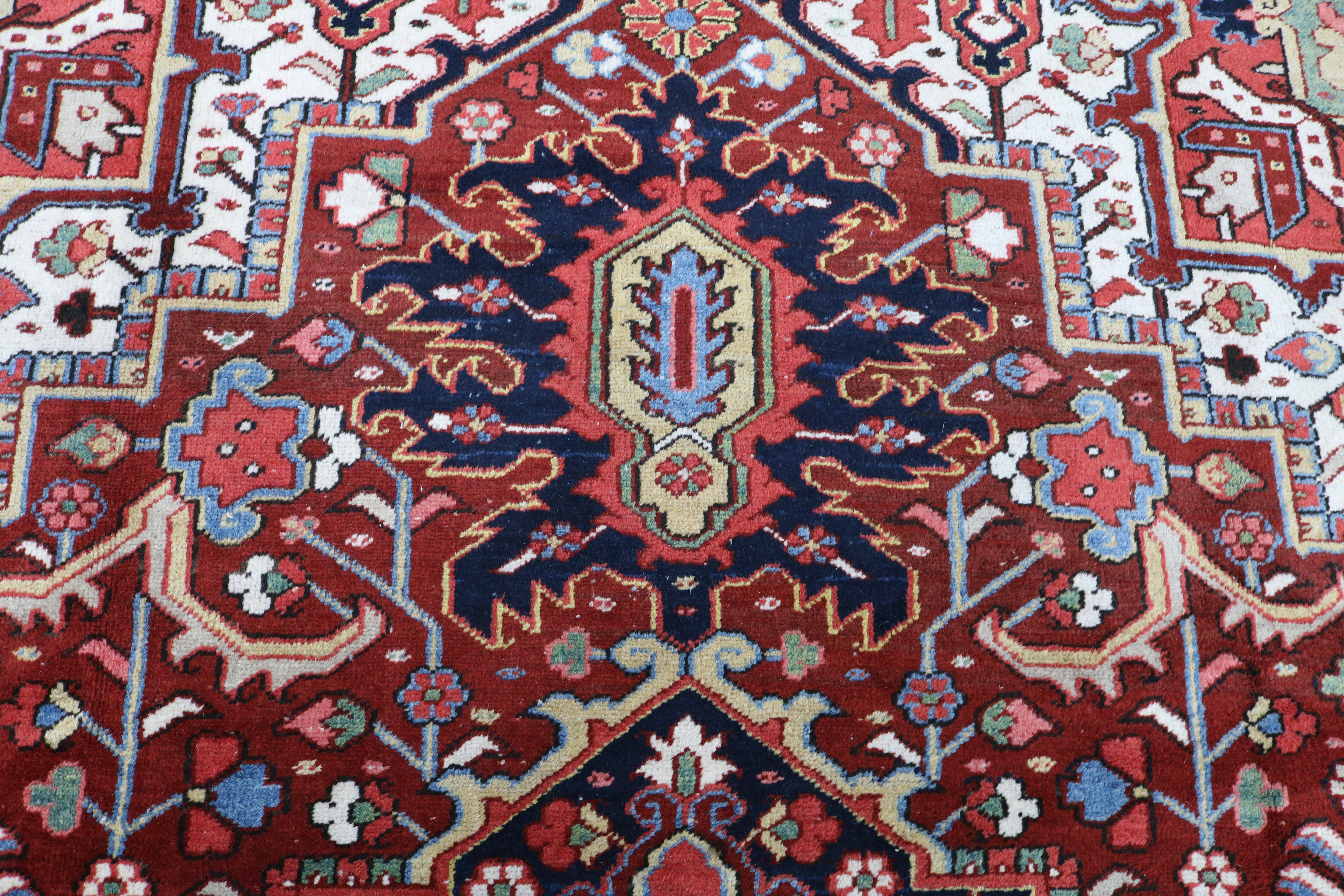 Close-up of hand-knotted wool texture on fine antique Persian Heriz carpet
