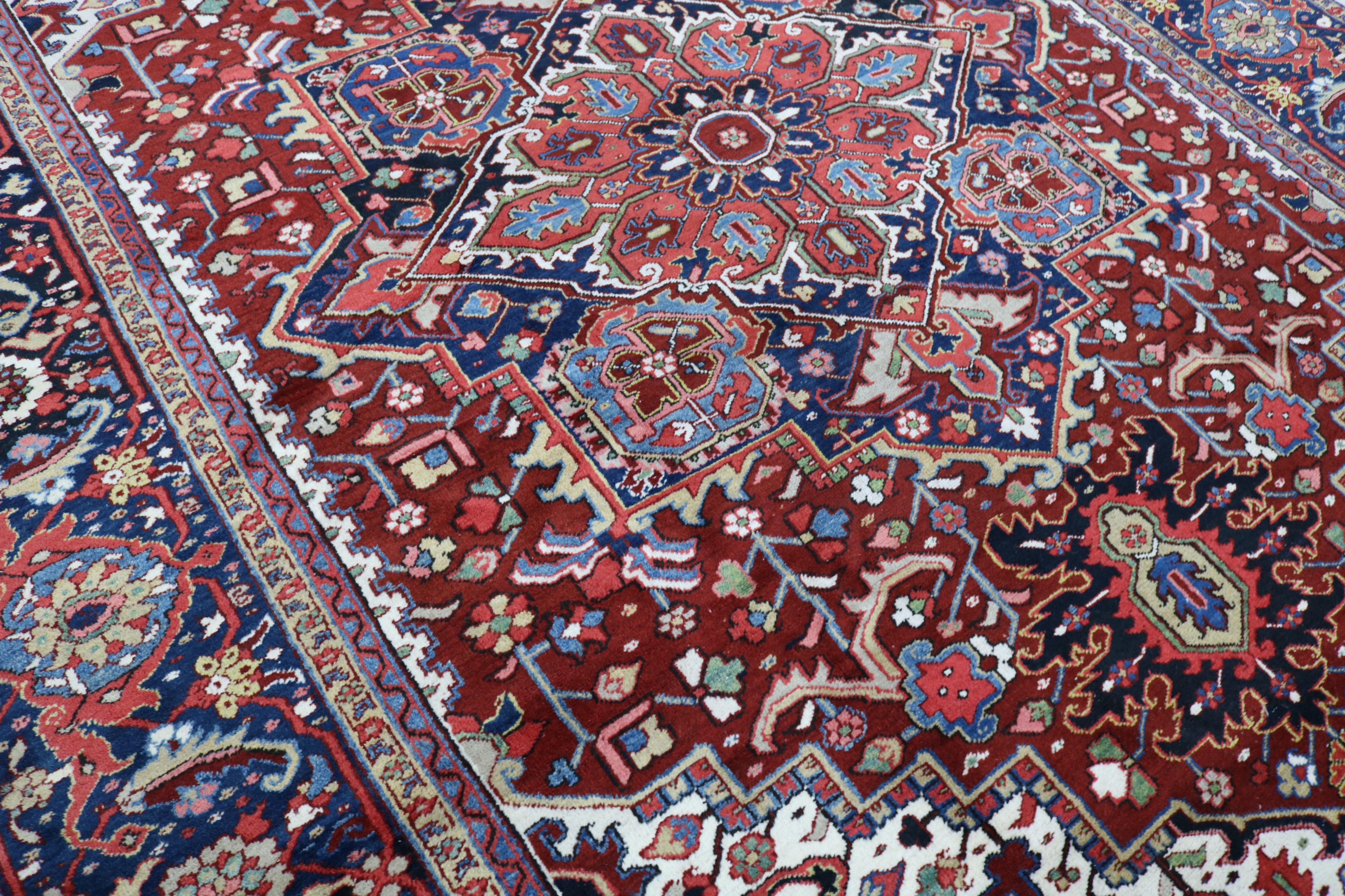 Close-up of hand-knotted wool texture on fine antique Persian Heriz carpet
