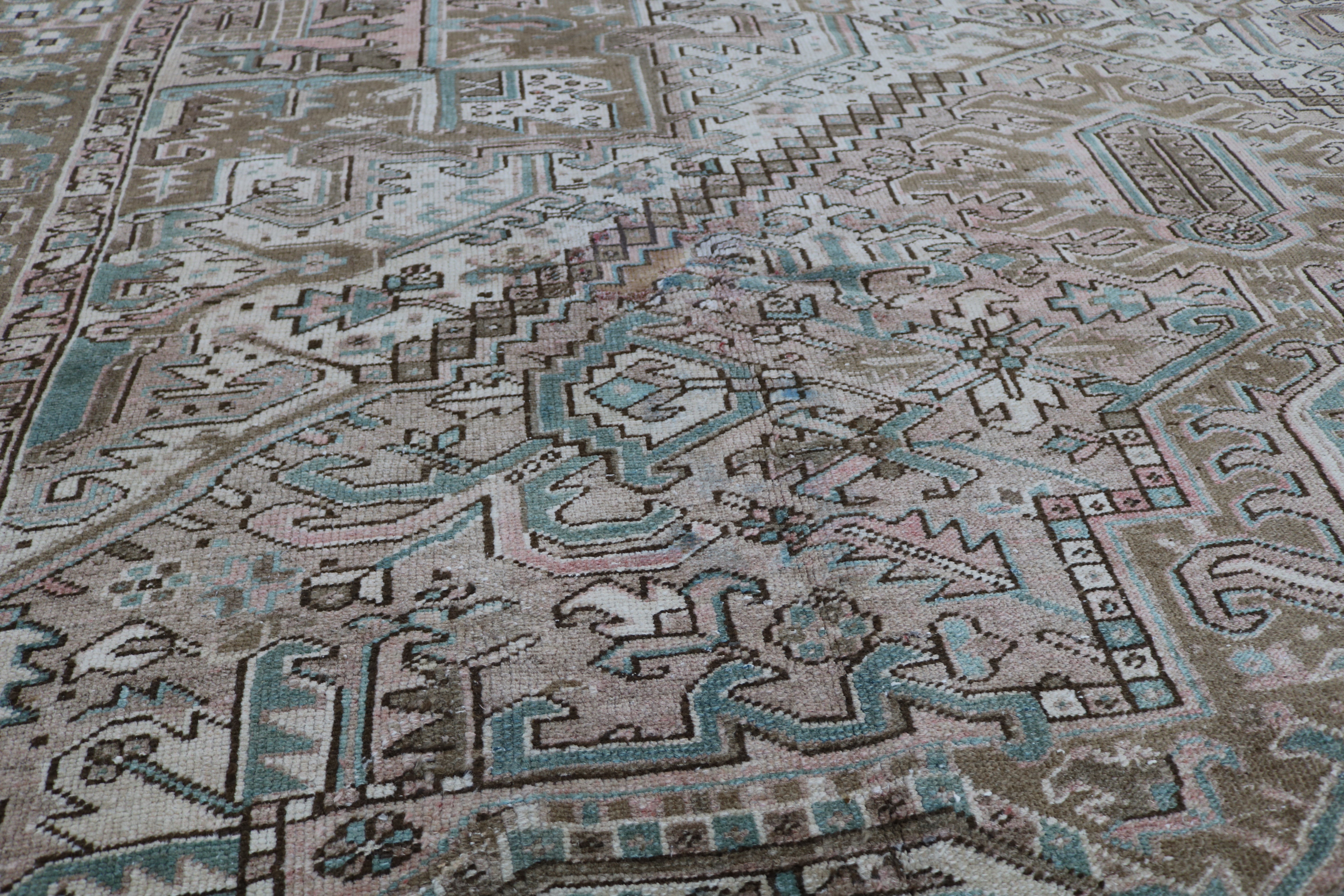 Close-up of hand-knotted wool texture on antique Persian Heriz carpet
