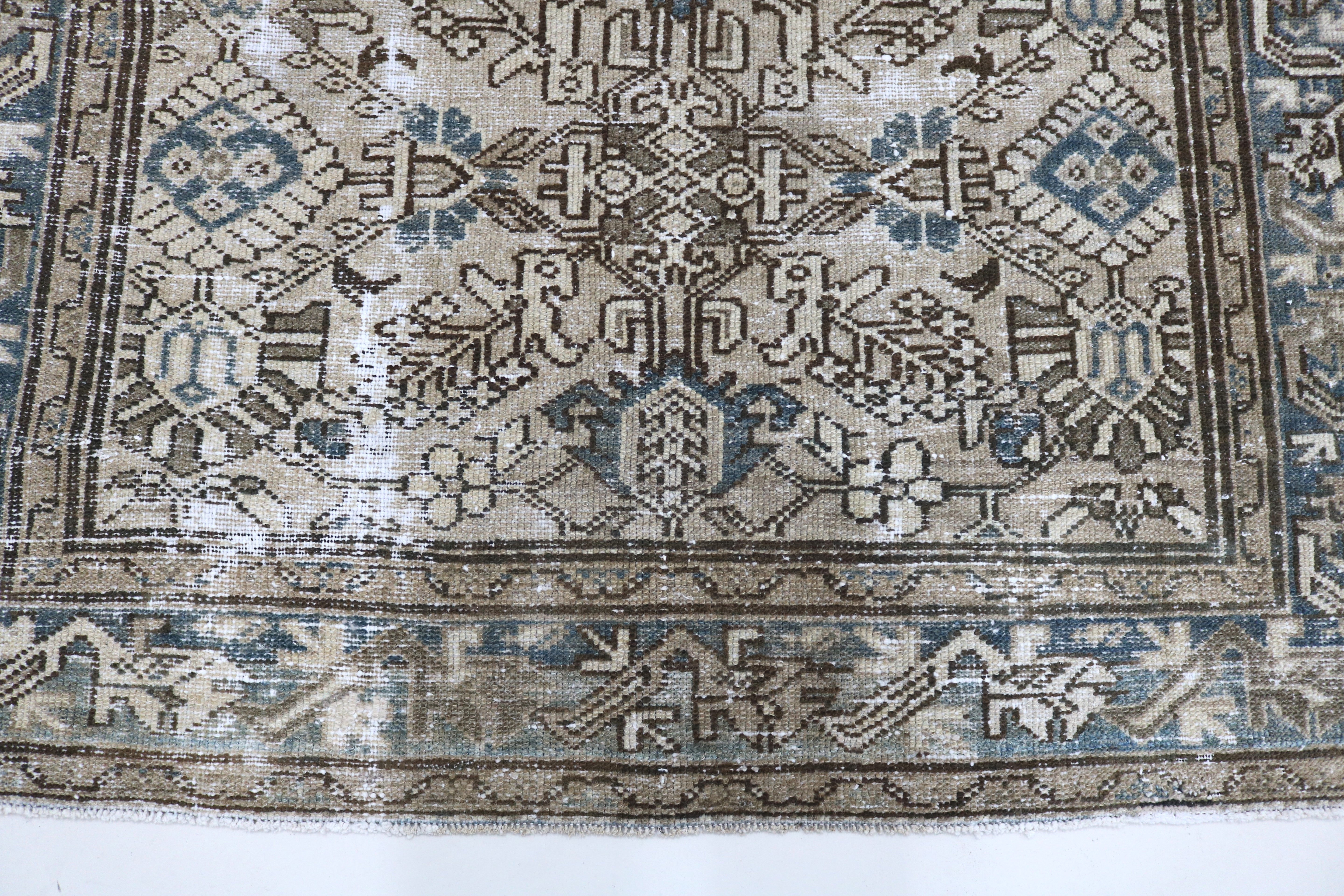 Close-up of hand-knotted wool texture on antique Persian Karaja rug
