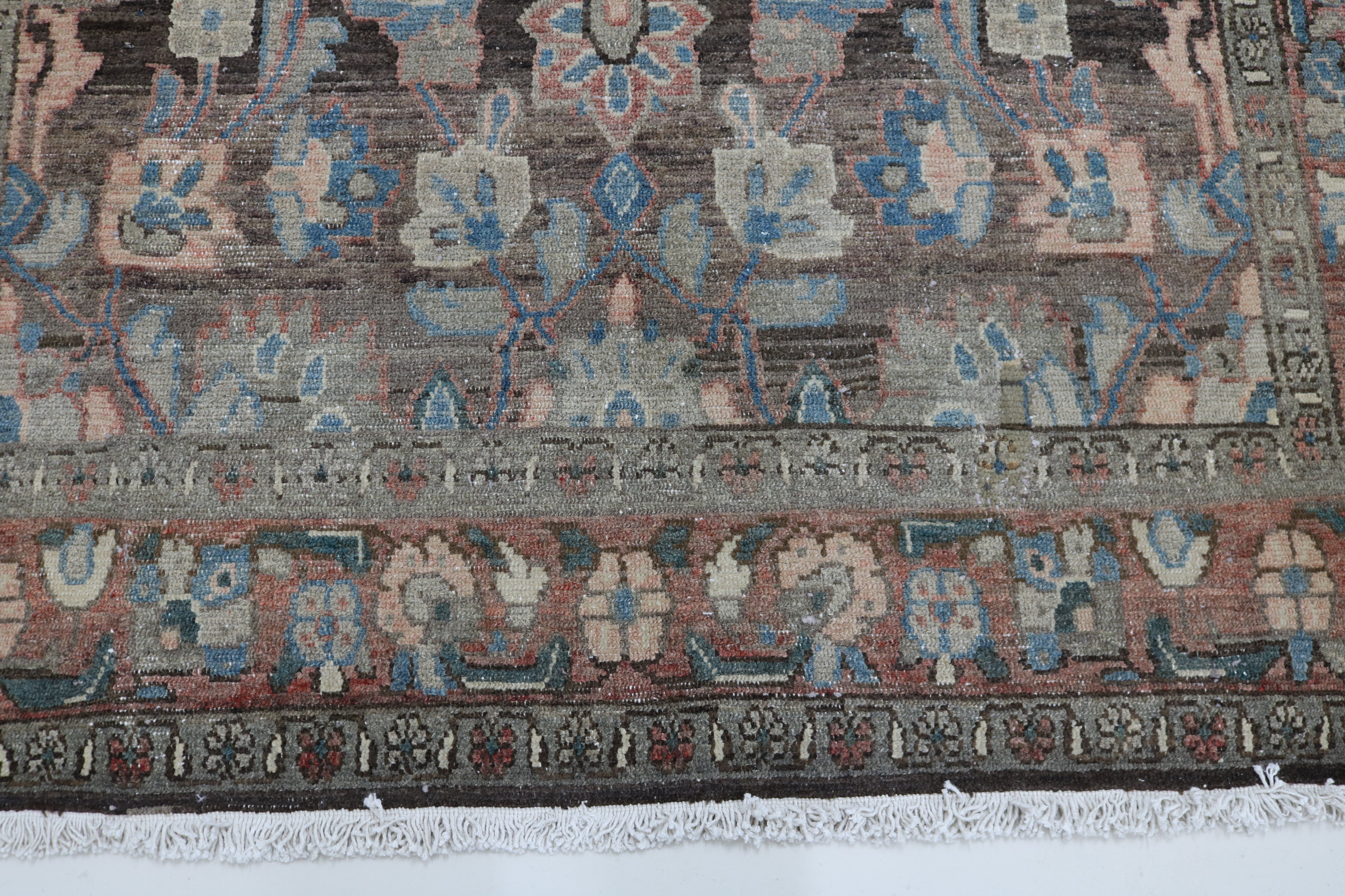 Close-up of hand-knotted wool texture on antique Persian Malayer rug

