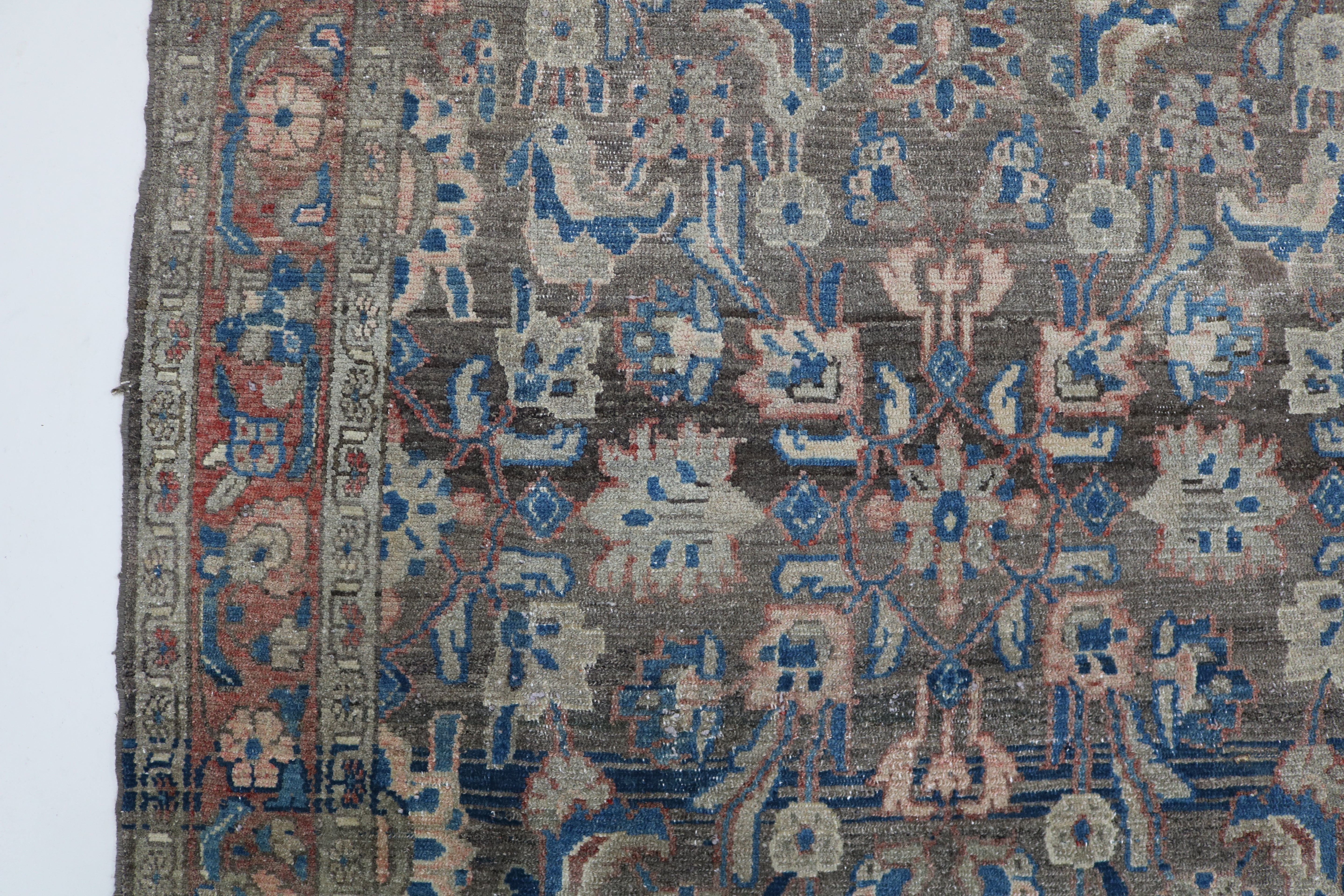 Close-up of hand-knotted wool texture on antique Persian Malayer rug
