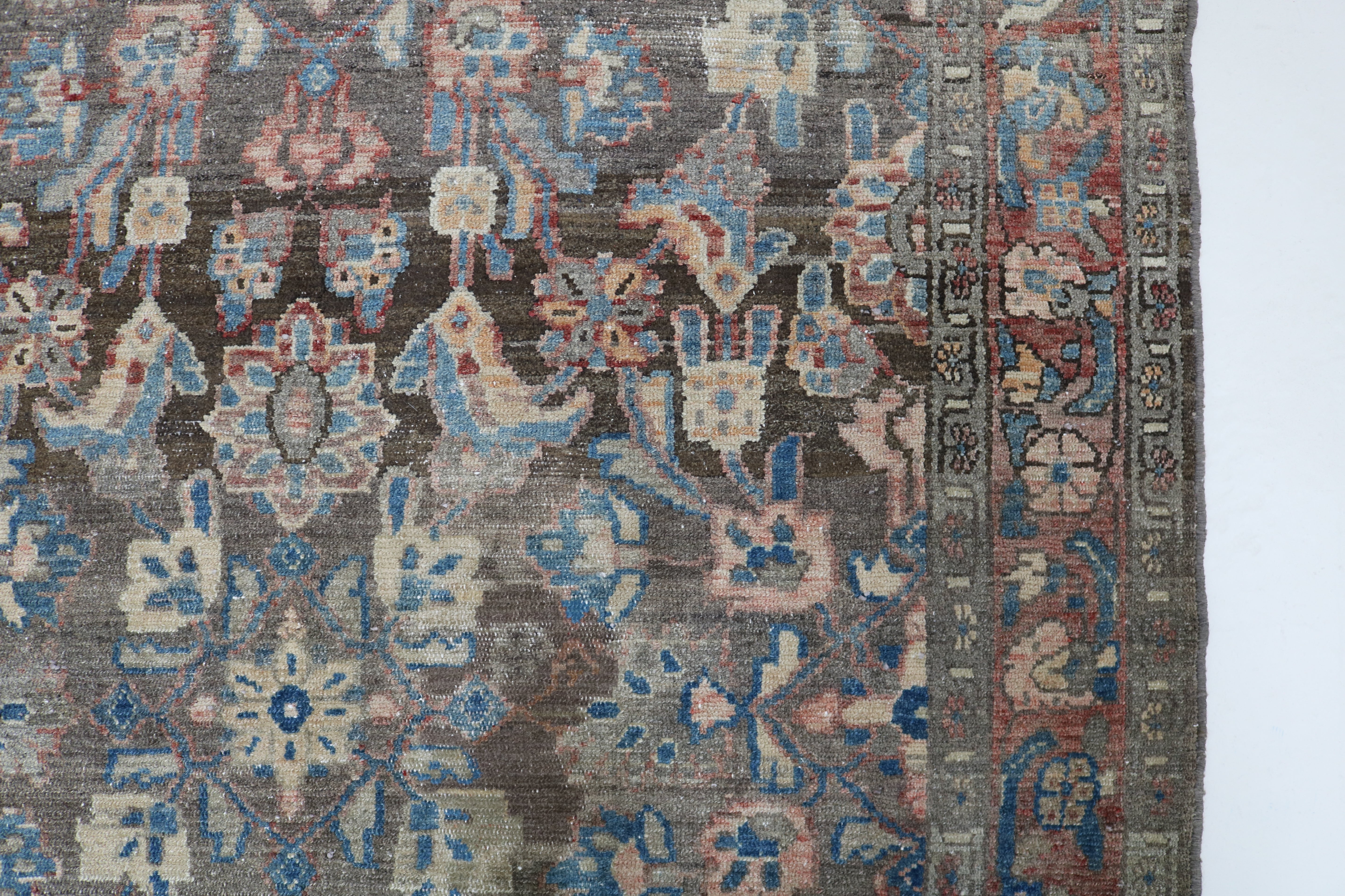 Close-up of hand-knotted wool texture on antique Persian Malayer rug
