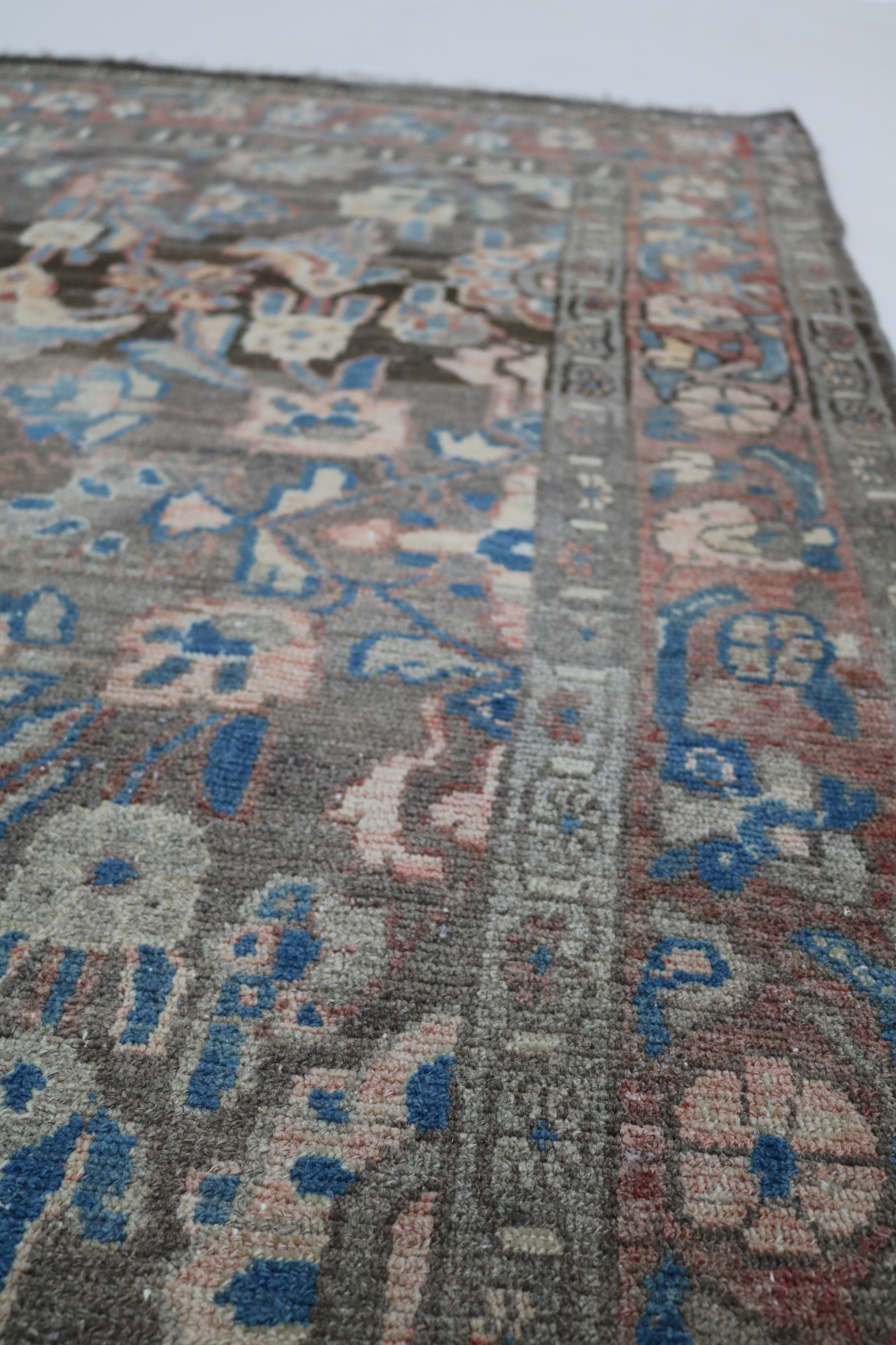 Close-up of hand-knotted wool texture on antique Persian Malayer rug
