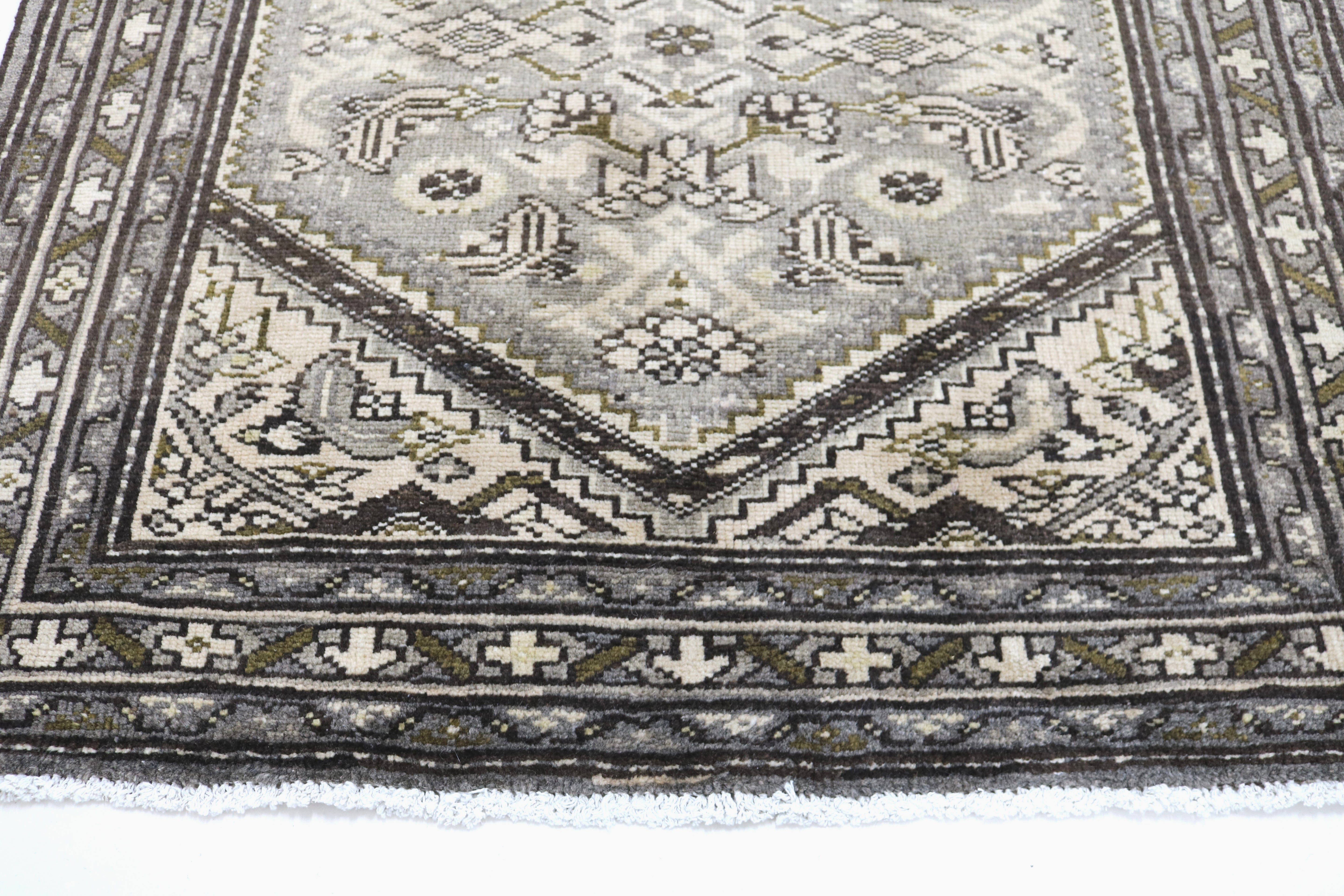 Close-up of hand-knotted wool texture on antique Persian Malayer runner
