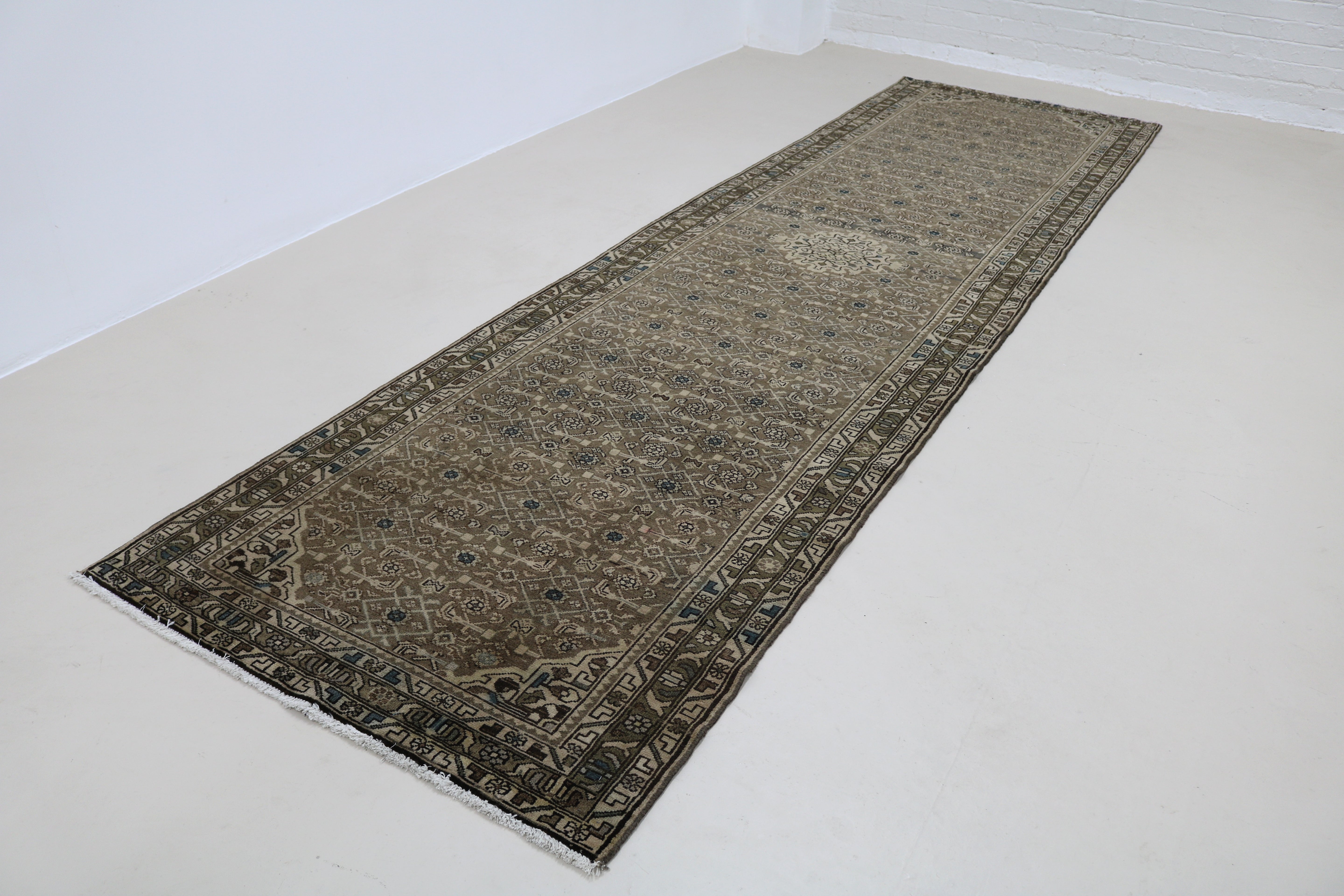 Angled view of antique Persian Malayer runner highlighting overall pattern and proportions
