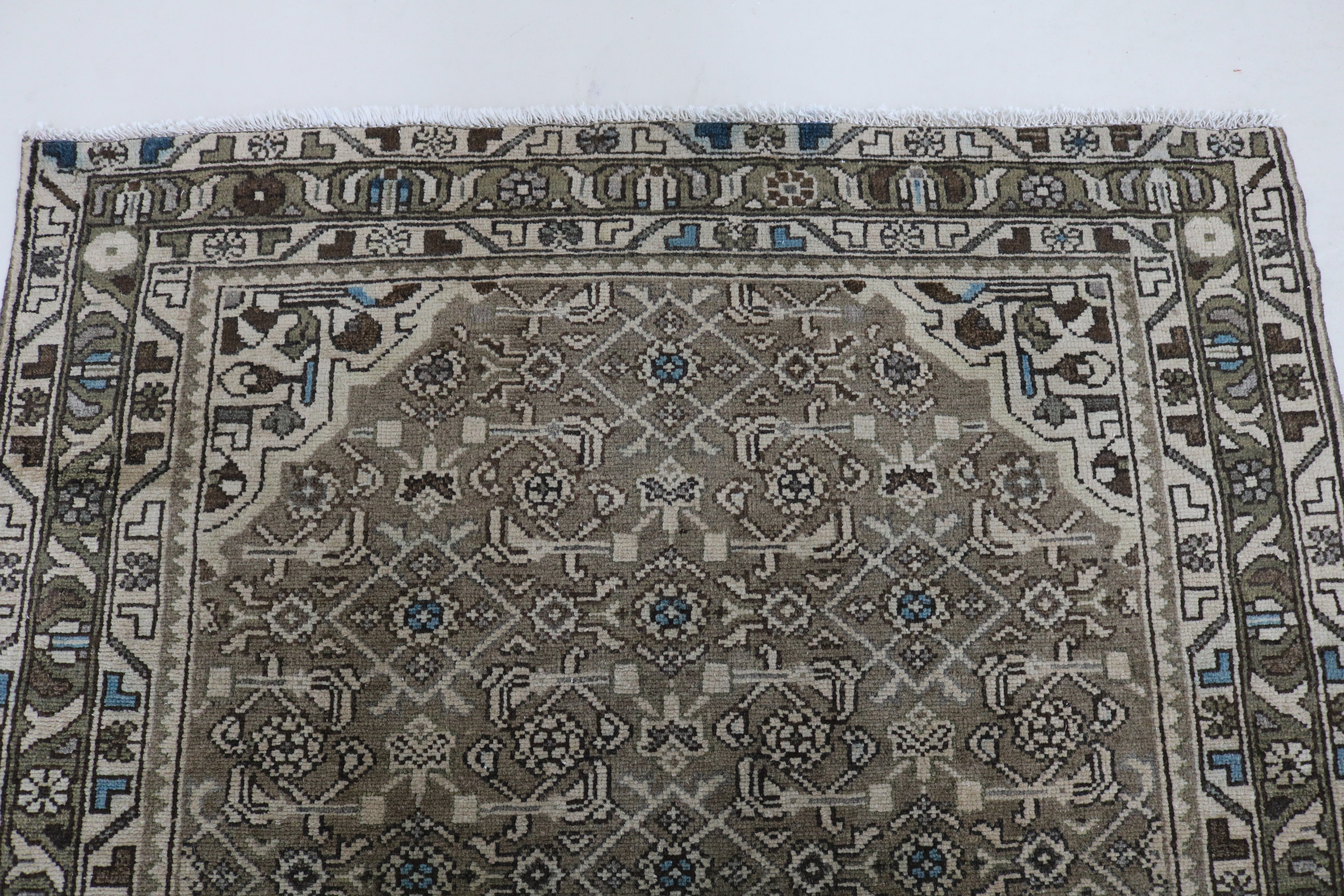 Close-up of hand-knotted wool texture on antique Persian Malayer runner
