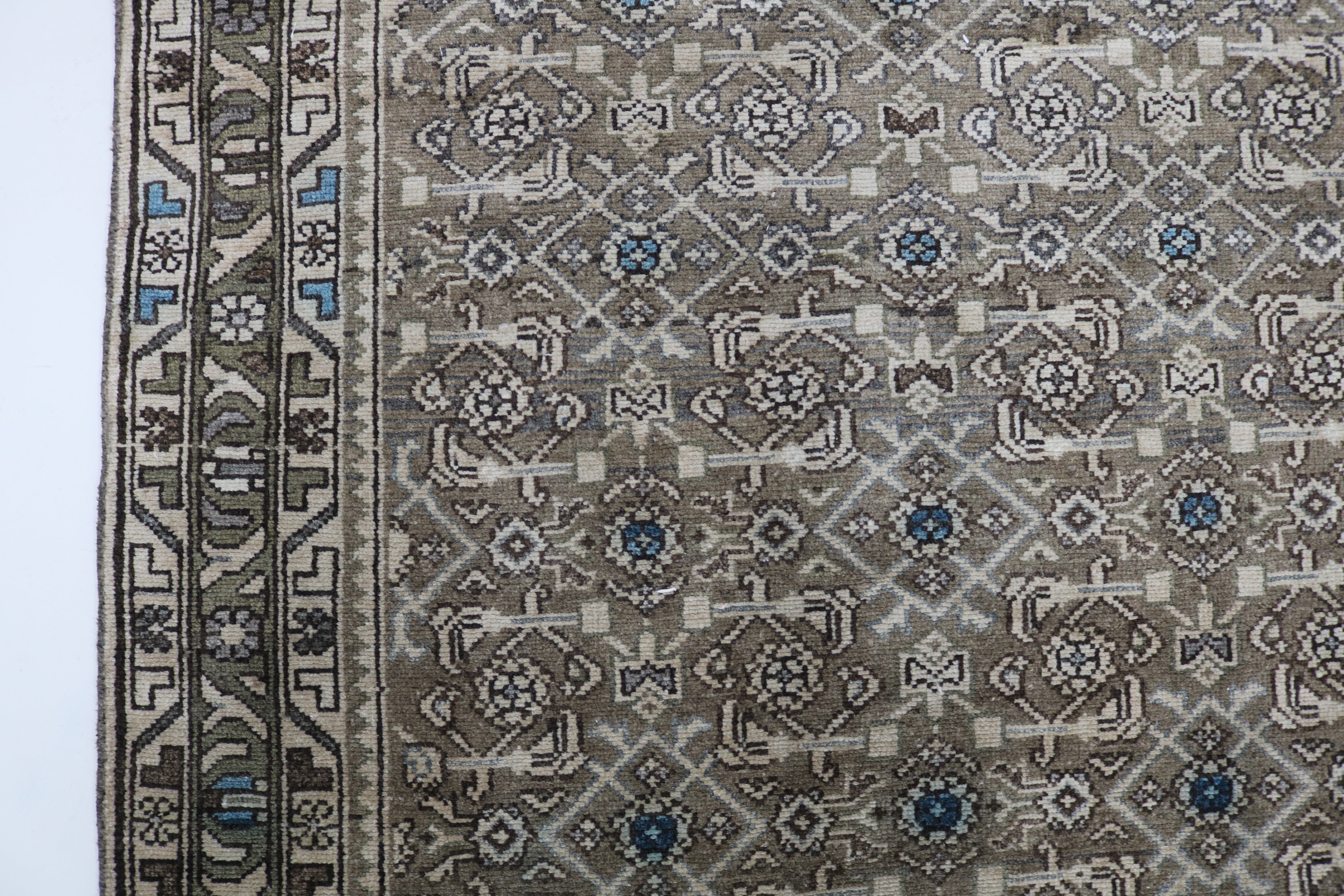 Close-up of hand-knotted wool texture on antique Persian Malayer runner
