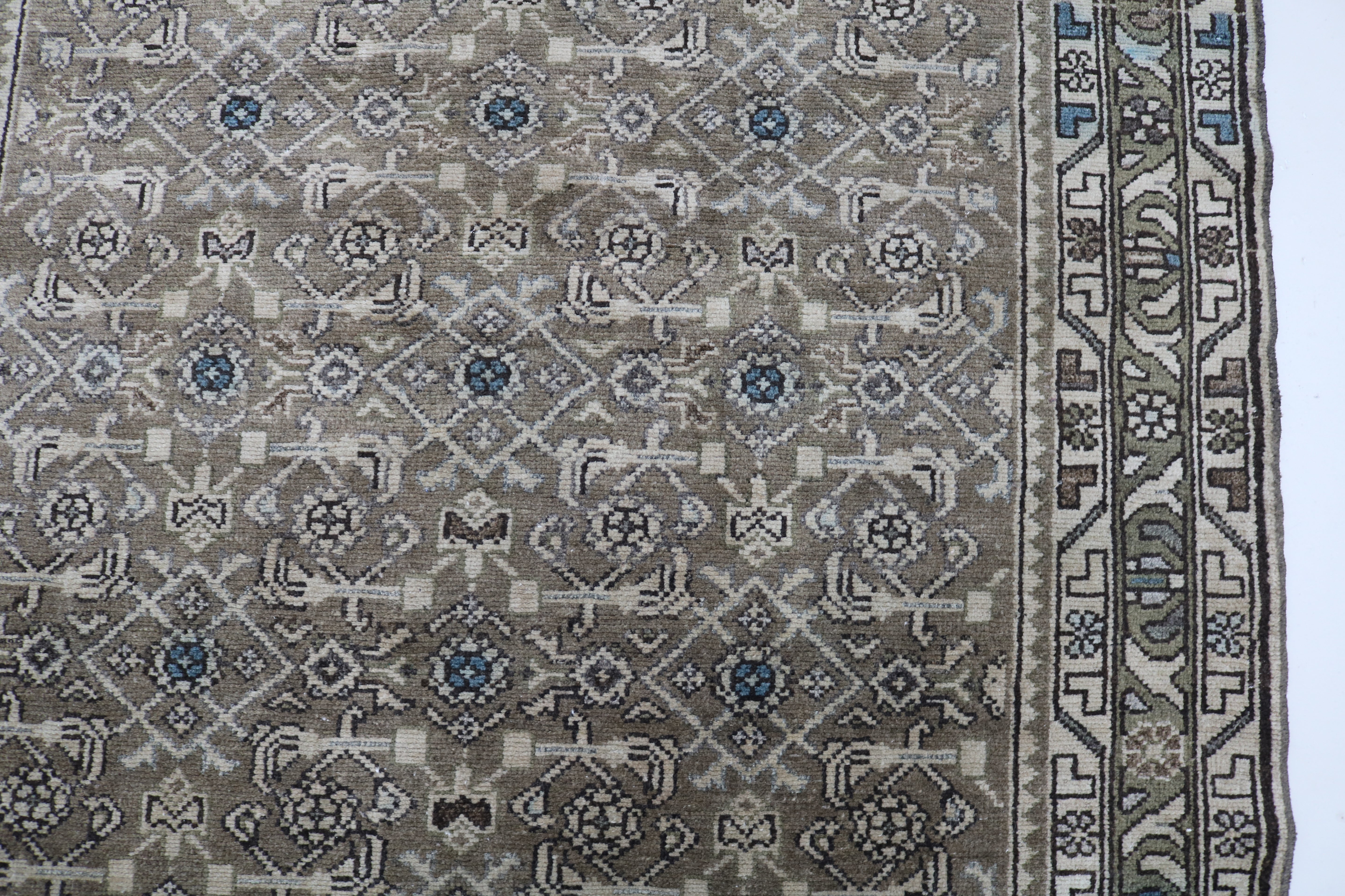 Close-up of hand-knotted wool texture on antique Persian Malayer runner
