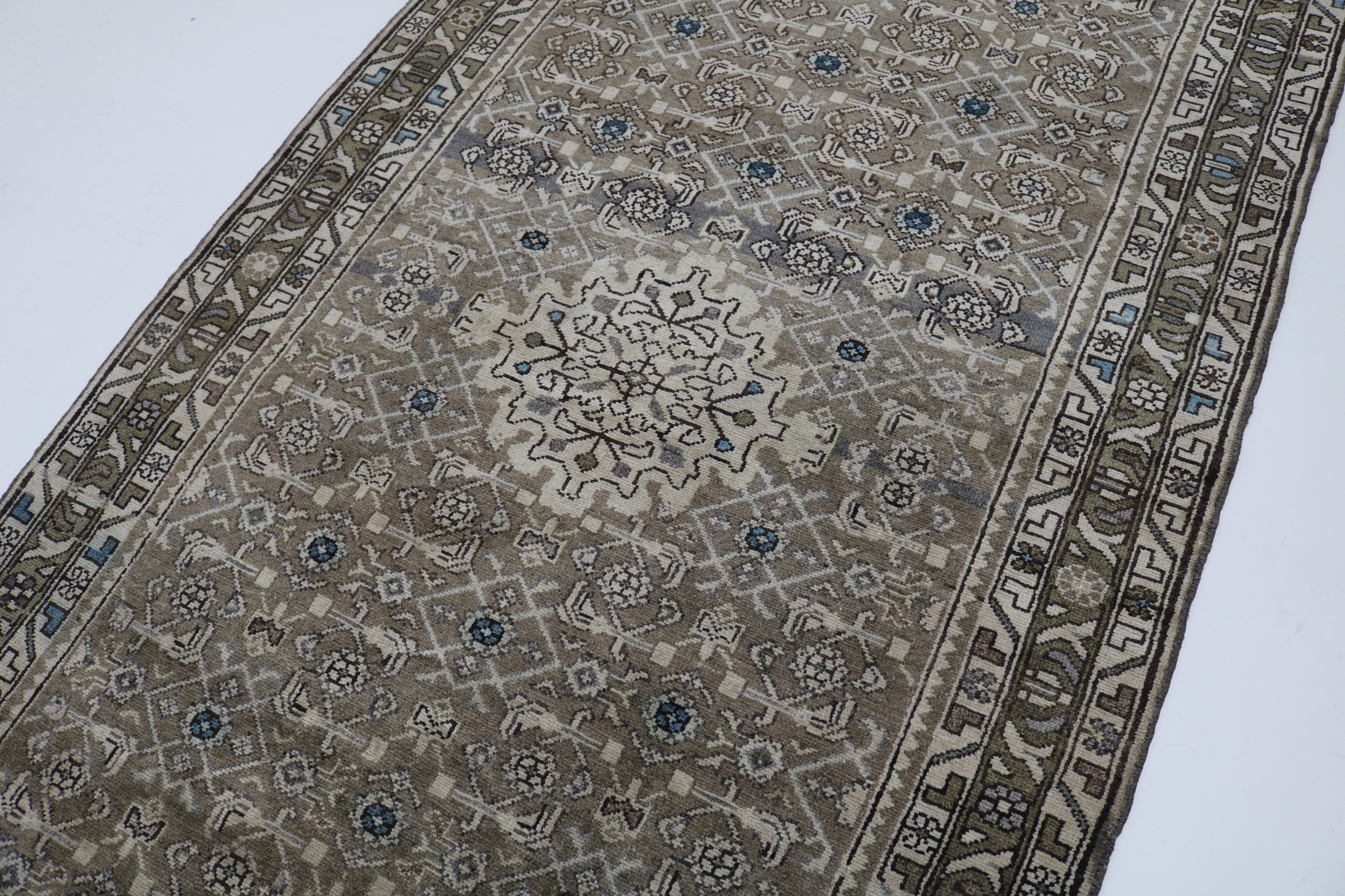 Close-up of hand-knotted wool texture on antique Persian Malayer runner

