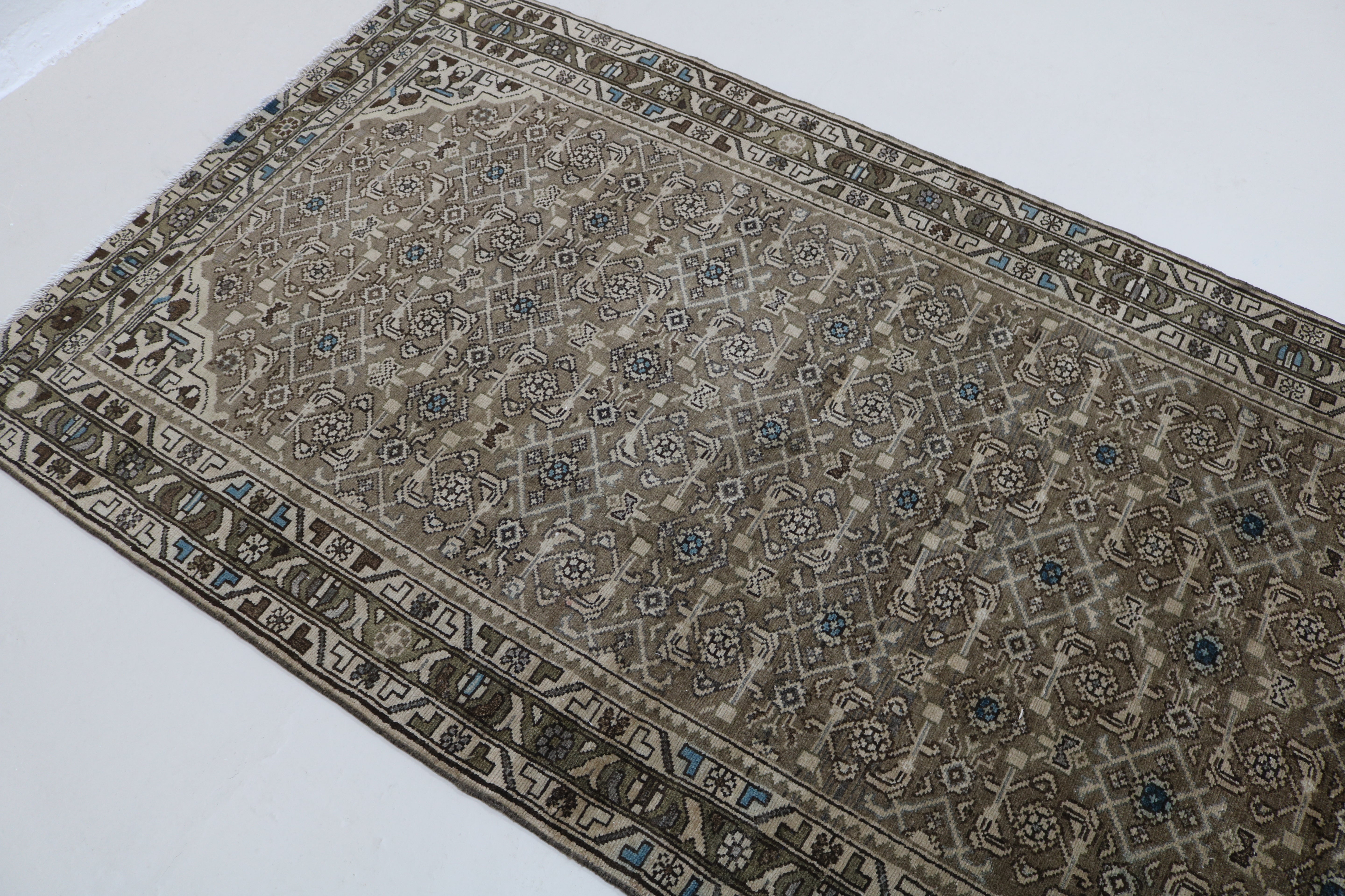 Close-up of hand-knotted wool texture on antique Persian Malayer runner
