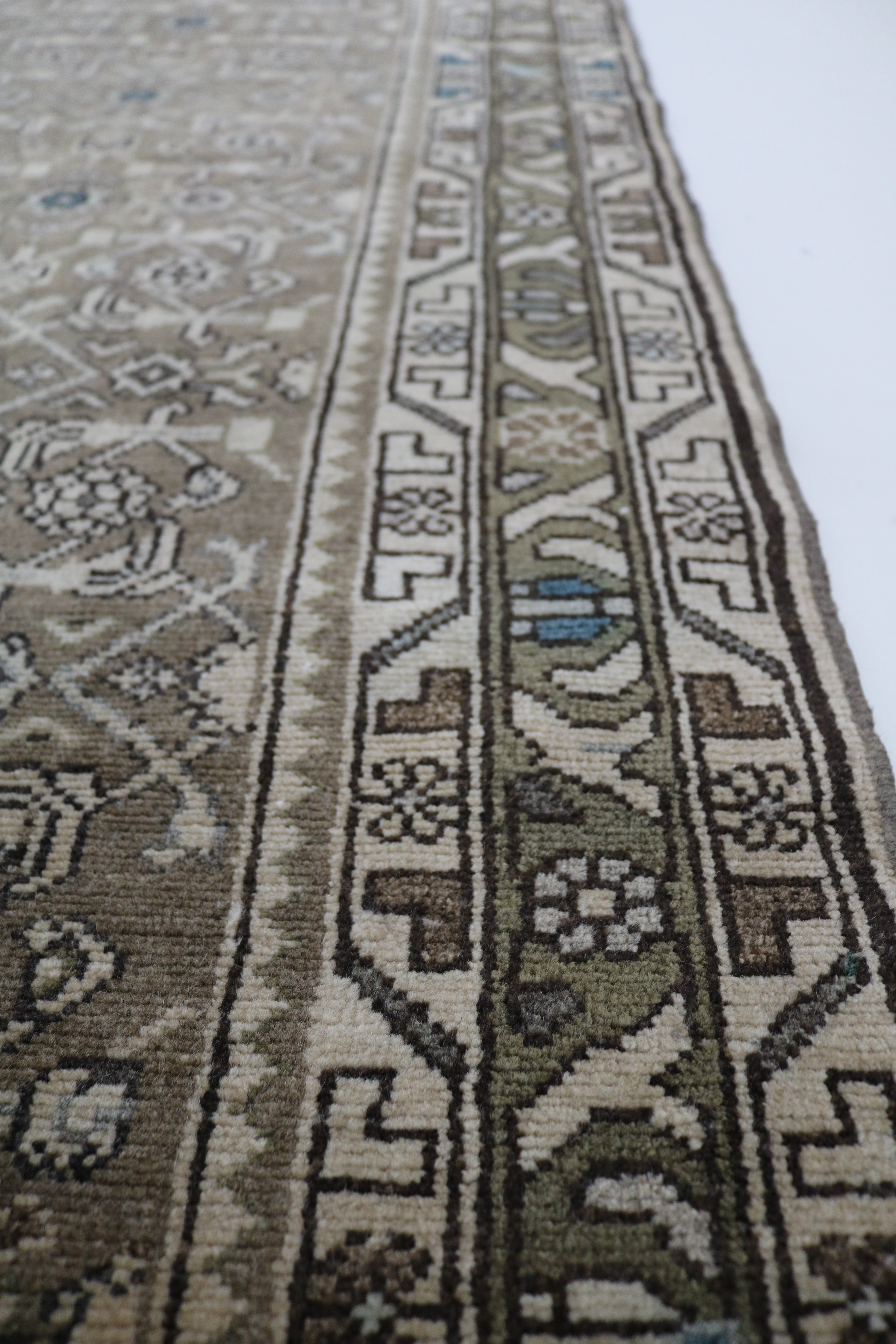 Close-up of hand-knotted wool texture on antique Persian Malayer runner
