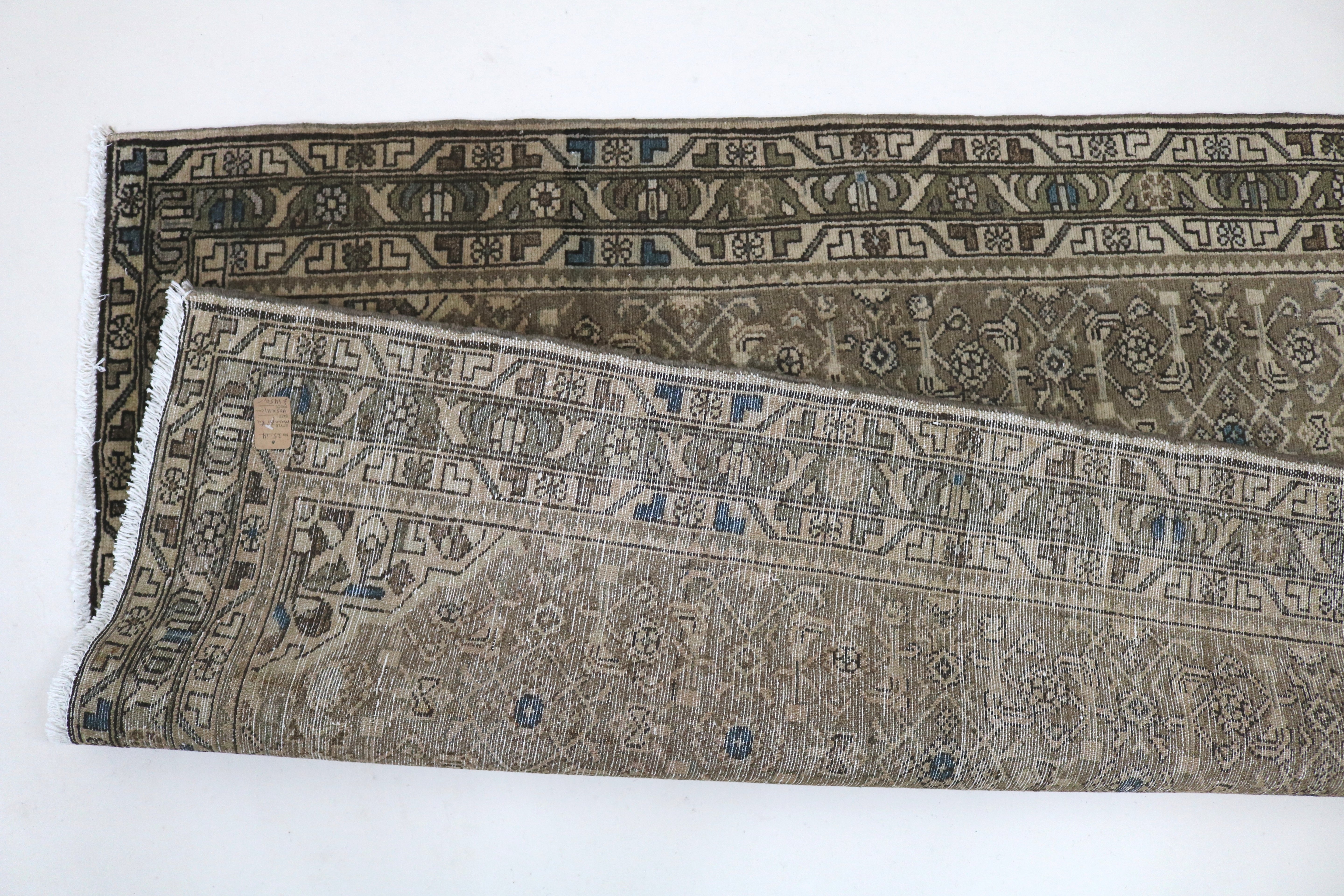 Close-up of hand-knotted wool texture on antique Persian Malayer runner
